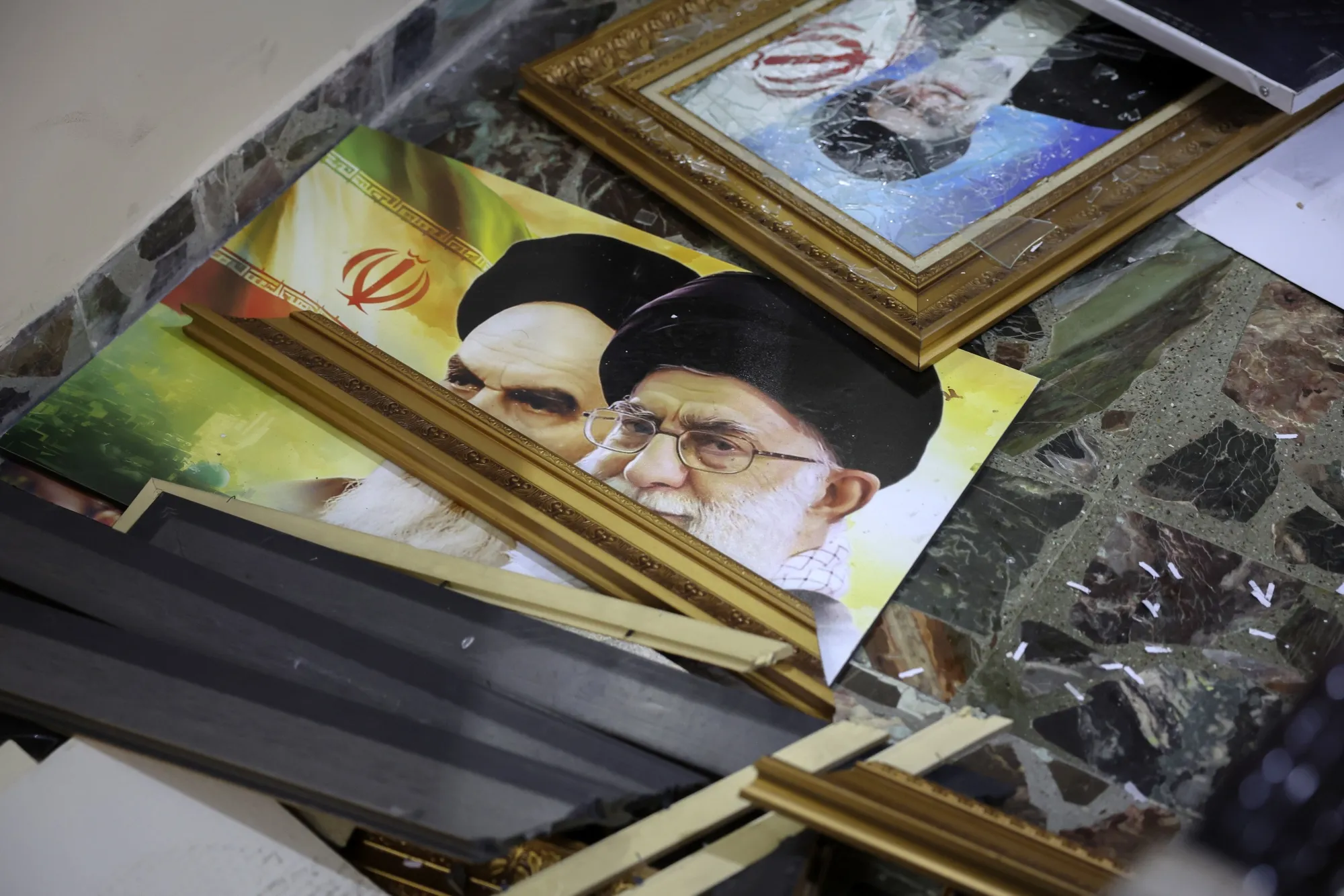 Broken pictures of Ayatollah Ruhollah Khomeini and Ayatollah Ali Khamenei lie on the floor at the Iranian embassy&nbsp;after opposition forces took control of Damascus&nbsp;on Dec. 8.