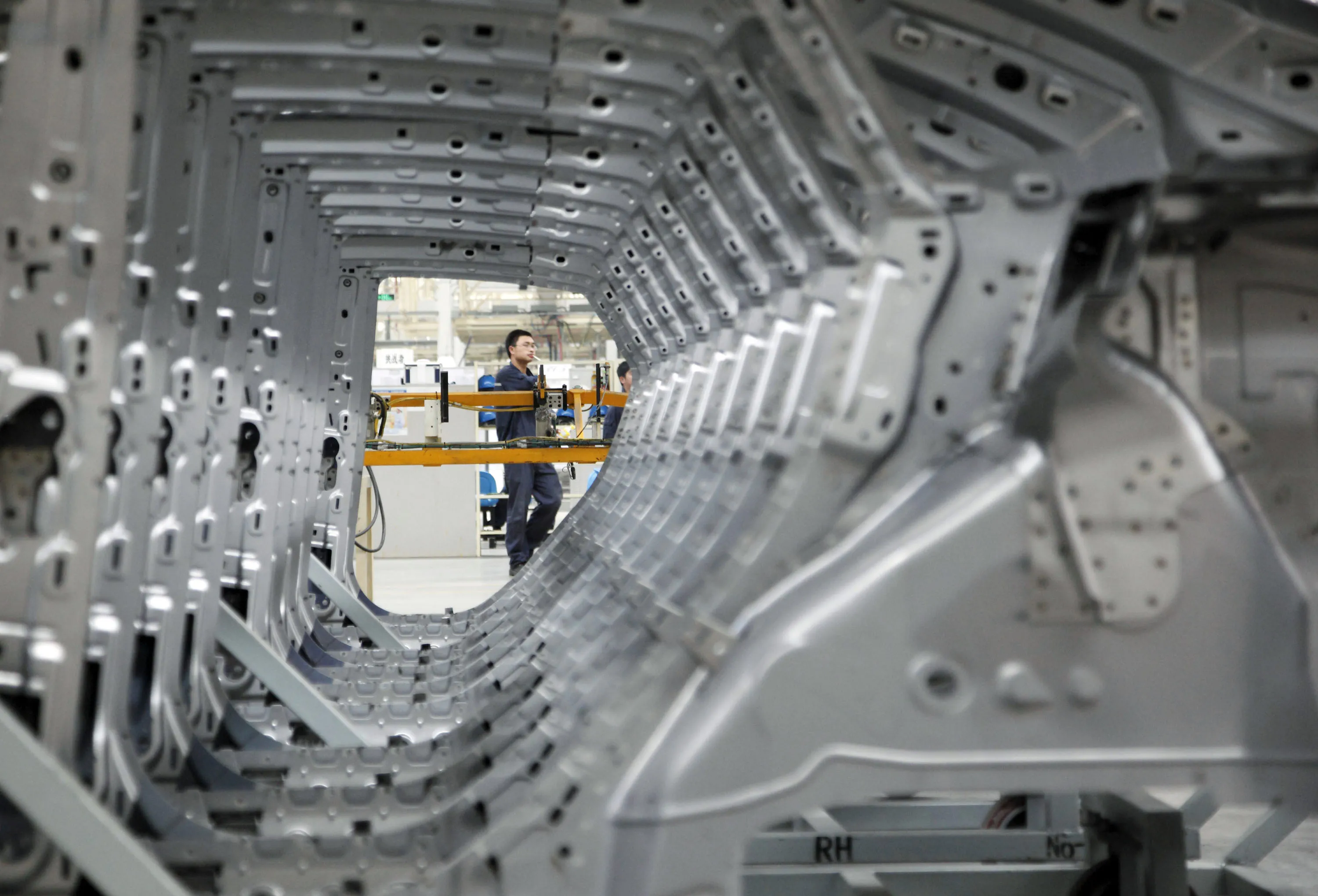 A worker operates the assembly line at a Ford Plant in Nanjing, China.&nbsp;