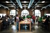 Employees help customers at the Apple Inc. Williamsburg store in the Brooklyn borough of New York, U.S., on Friday, May 20, 2017. Apple Chief Executive Officer Tim Cook said in May that the company planned to invest at least $1 billion to back advanced manufacturing companies in the U.S. and help create jobs in the industry.