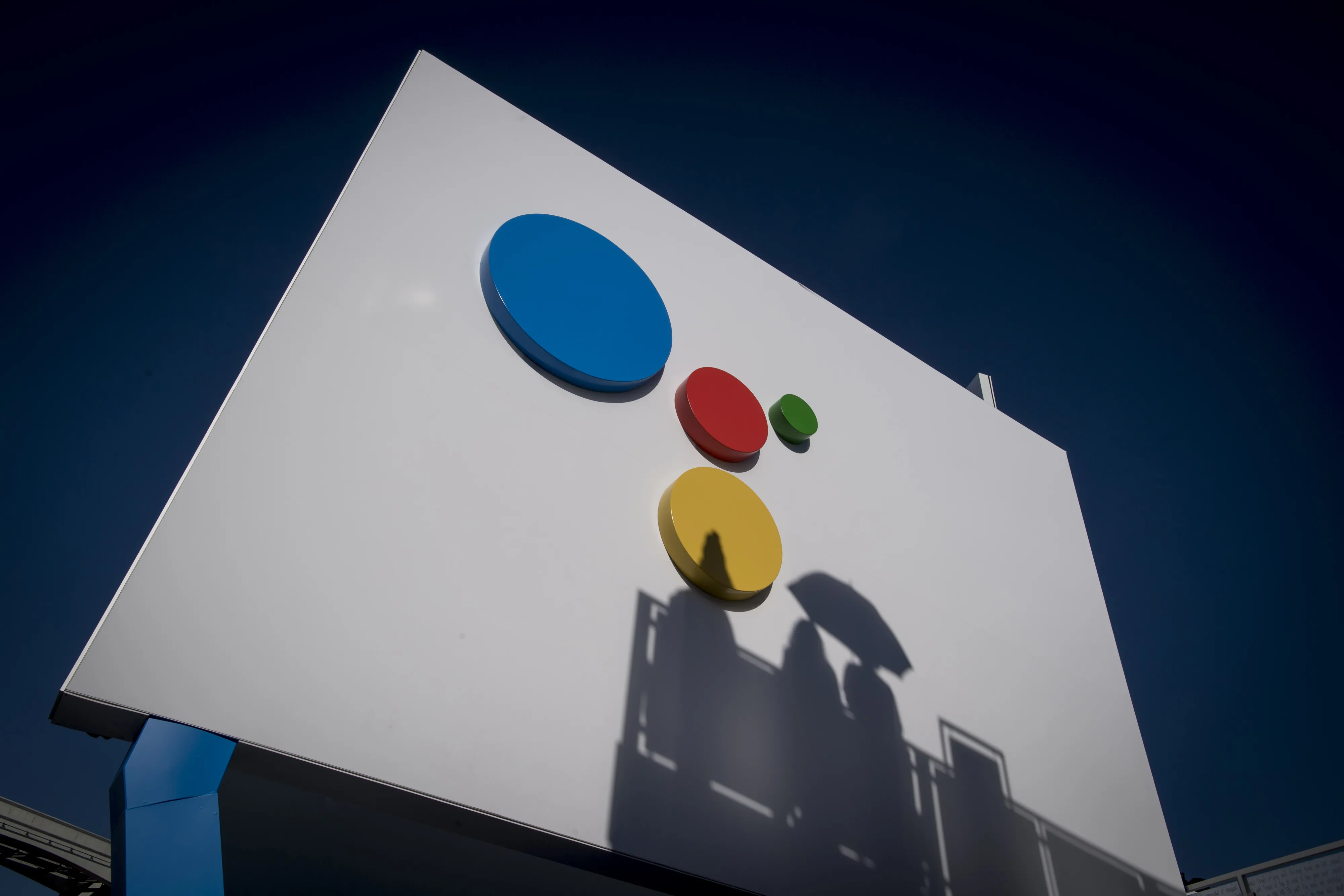 Shadows of attendees are seen on a wall at the Google Inc. booth during the 2018 Consumer Electronics Show (CES) in Las Vegas, Nevada, U.S., on Thursday, Jan. 11, 2018. Electric and driverless cars will remain a big part of this year's CES, as makers of high-tech cameras, batteries, and AI software vie to climb into automakers' dashboards.