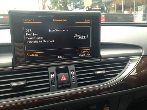 The dashboard has fine-grain wooden elements and a pop-up screen controlled by a knob down below.