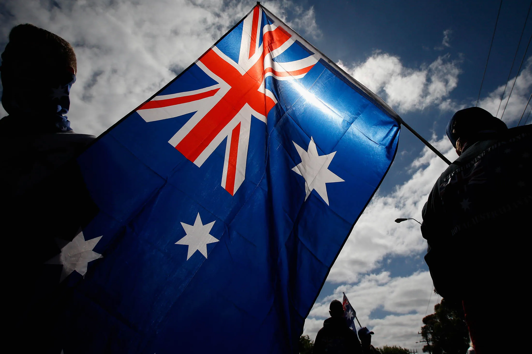 MELBOURNE, AUSTRALIA - NOVEMBER 22: The Australian flag is waved by protesters during a Reclaim Australia rally held in Melton on November 22, 2015 in Melbourne, Australia. Protestors gathered near the Melton Community Hall to voice their opinions on Australia's laws and cultures.
