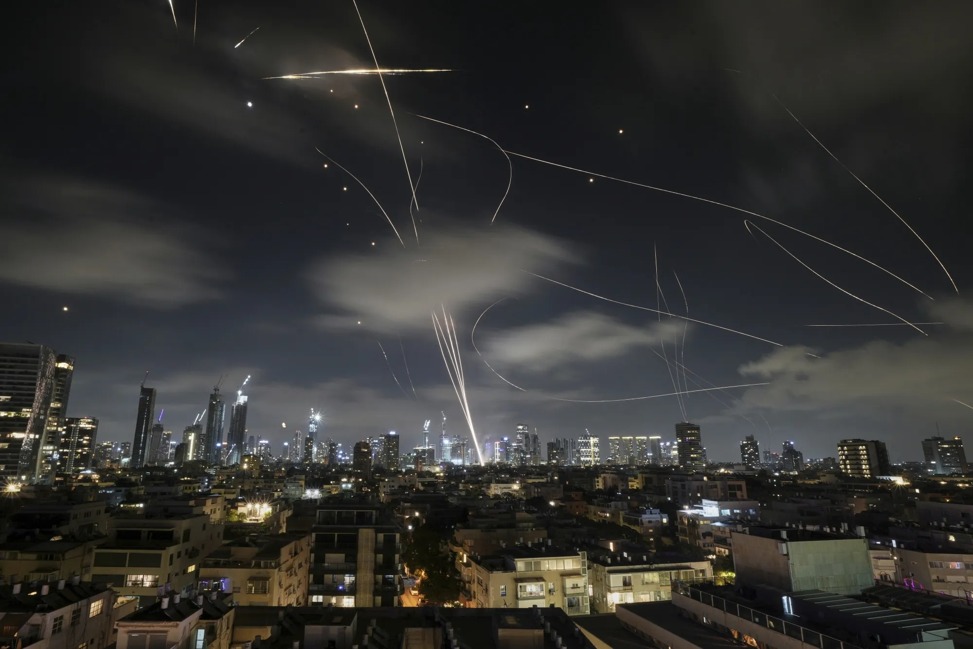 Israeli air defenses intercept Iranian missiles over Tel Aviv early on June 18.
