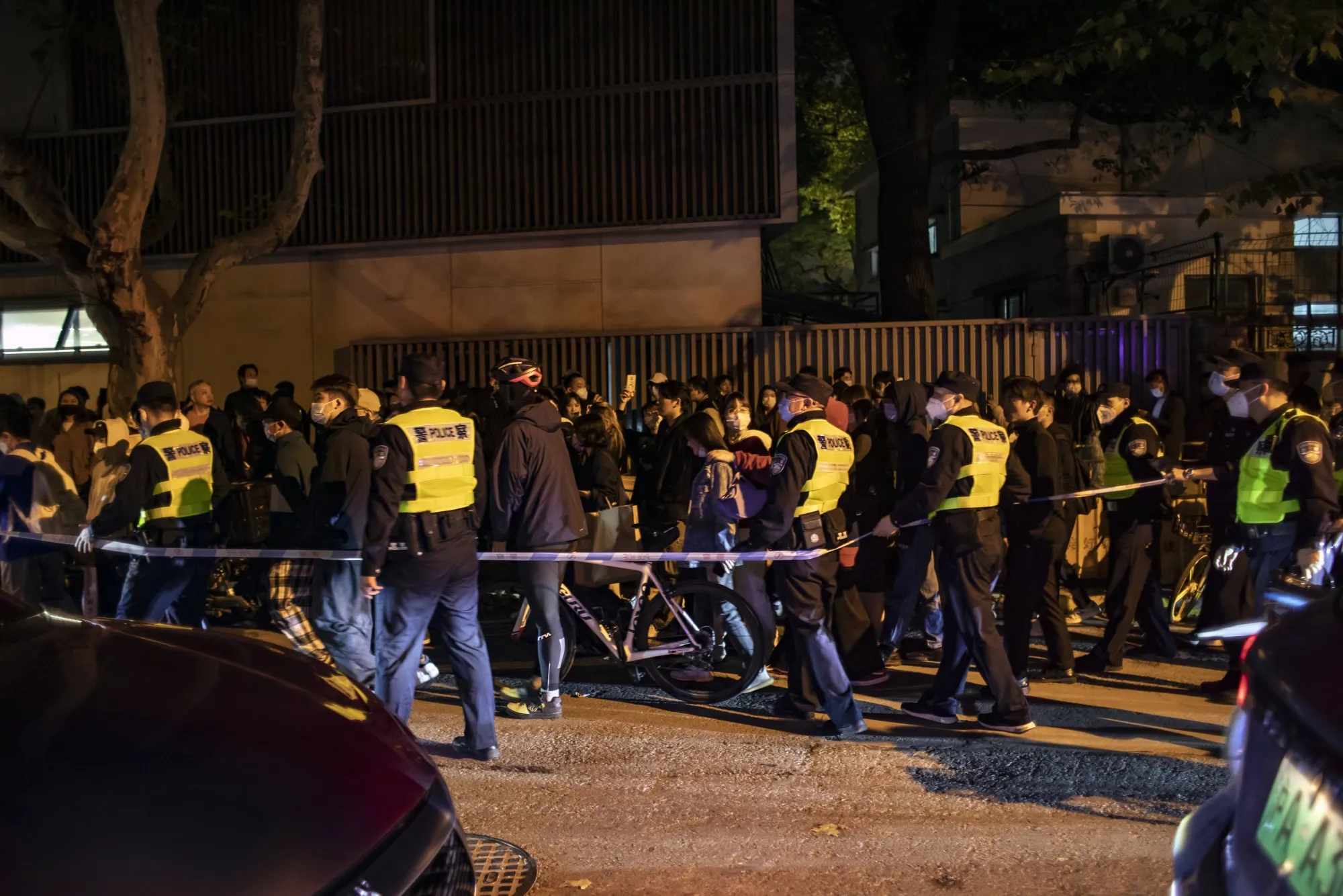 Police officers disperse crowds during a protest against Covid restrictions in Shanghai.