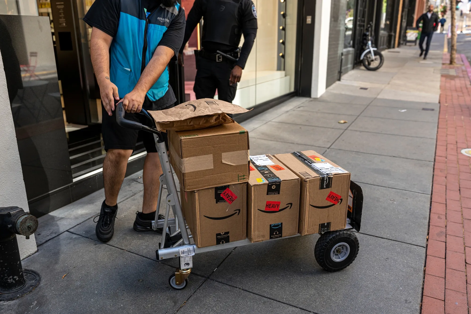 A worker delivers Amazon packages in San Francisco.