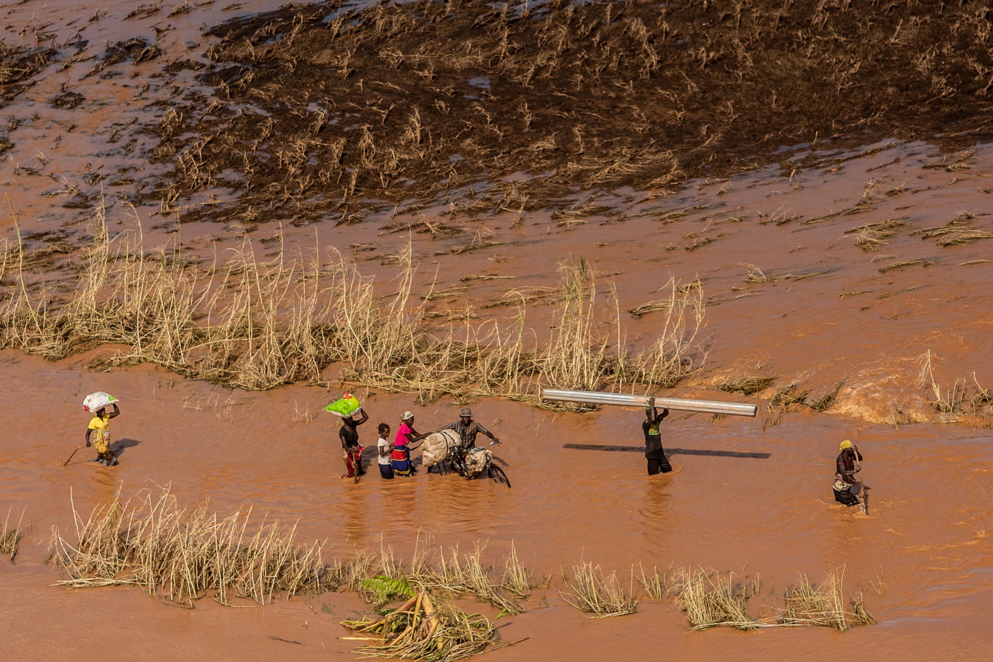 People wade through flood waters in Buzi, Mozambique, following Cyclone Idai in March.