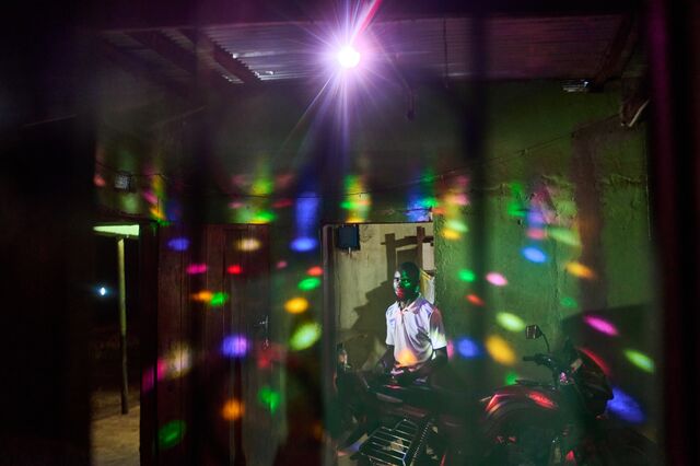 A night club owner in his bar powered from the min-grid in Chitandika.