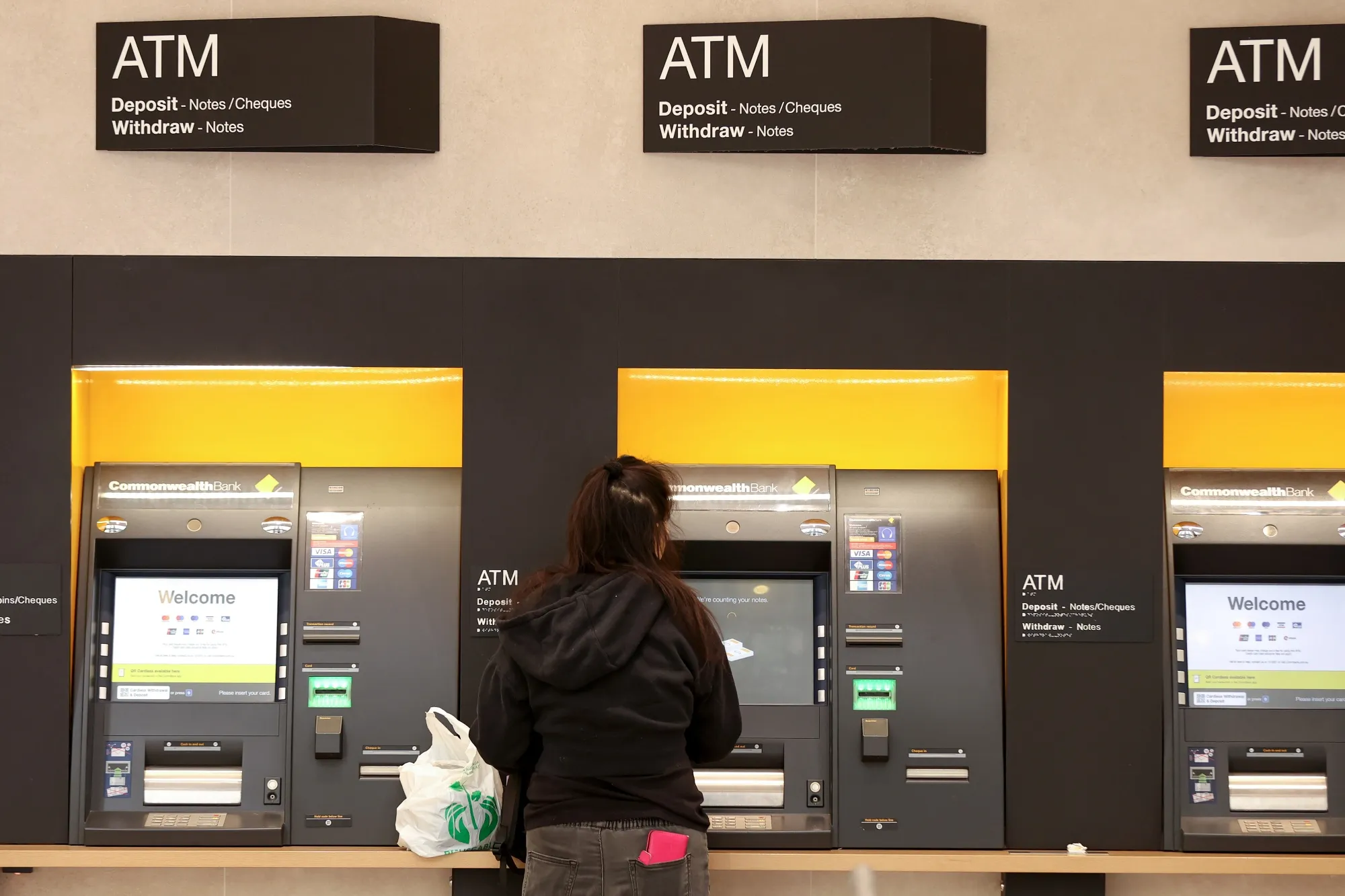 A customer uses an automated teller machine (ATM) at a Commonwealth Bank of Australia branch.