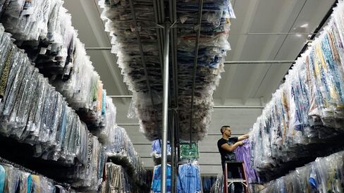 A worker pulls some tops from inventory to fill an order in Miami.