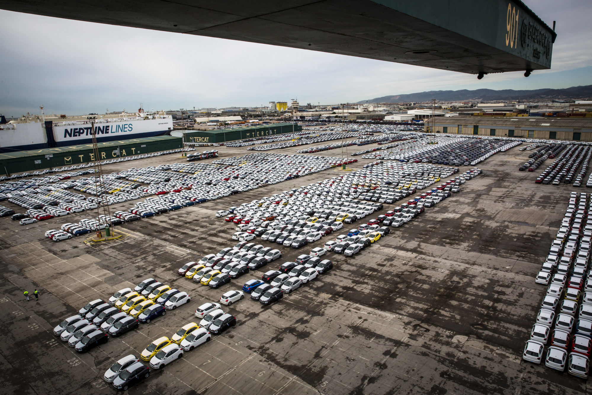 Newly manufactured automobiles sit on the dockside in the Auto Terminal SA parking lot at the port of Barcelona.