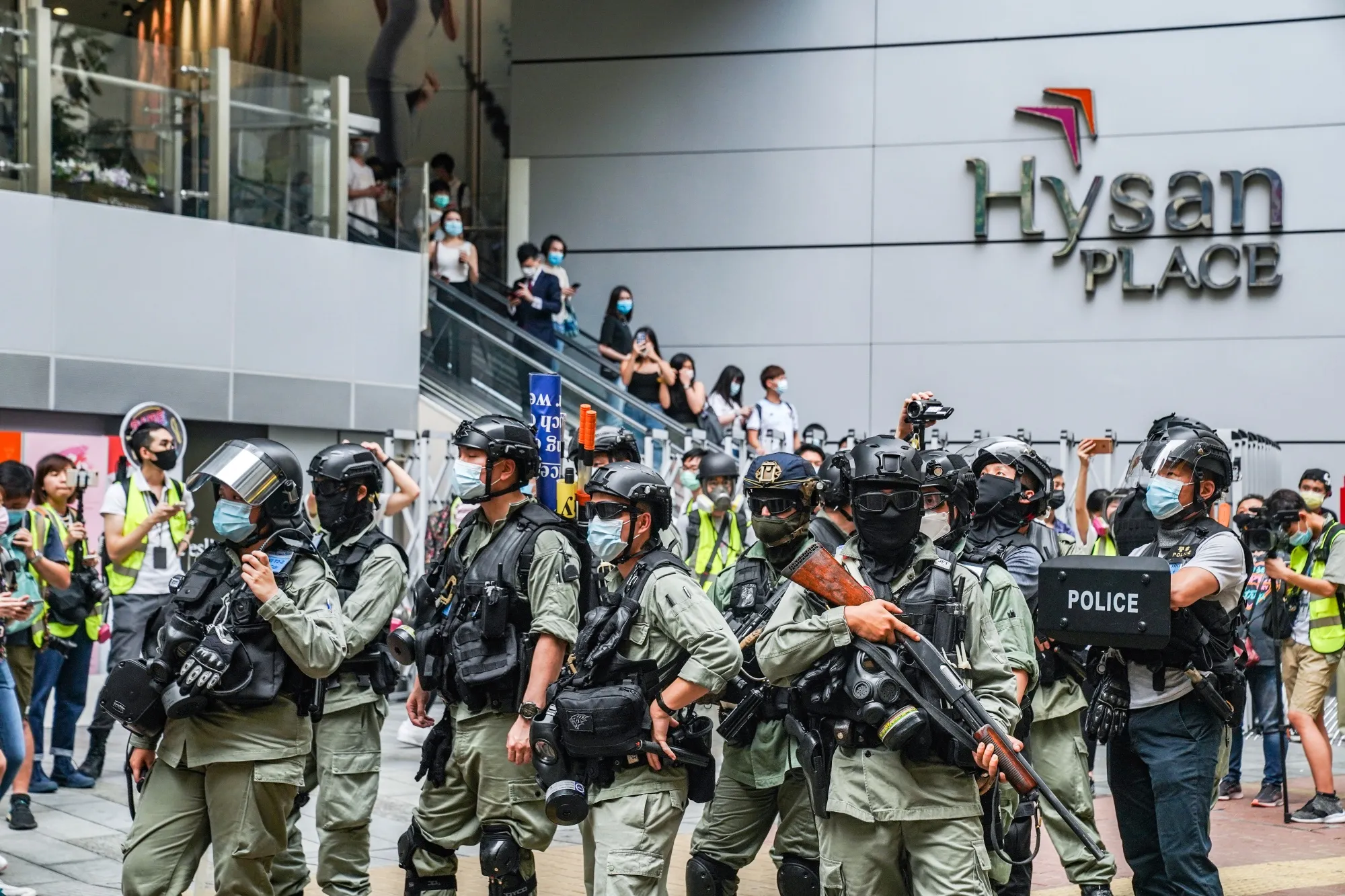 Riot police stand in front of the Hysan Place shopping mall in the Causeway Bay district on May 27.
