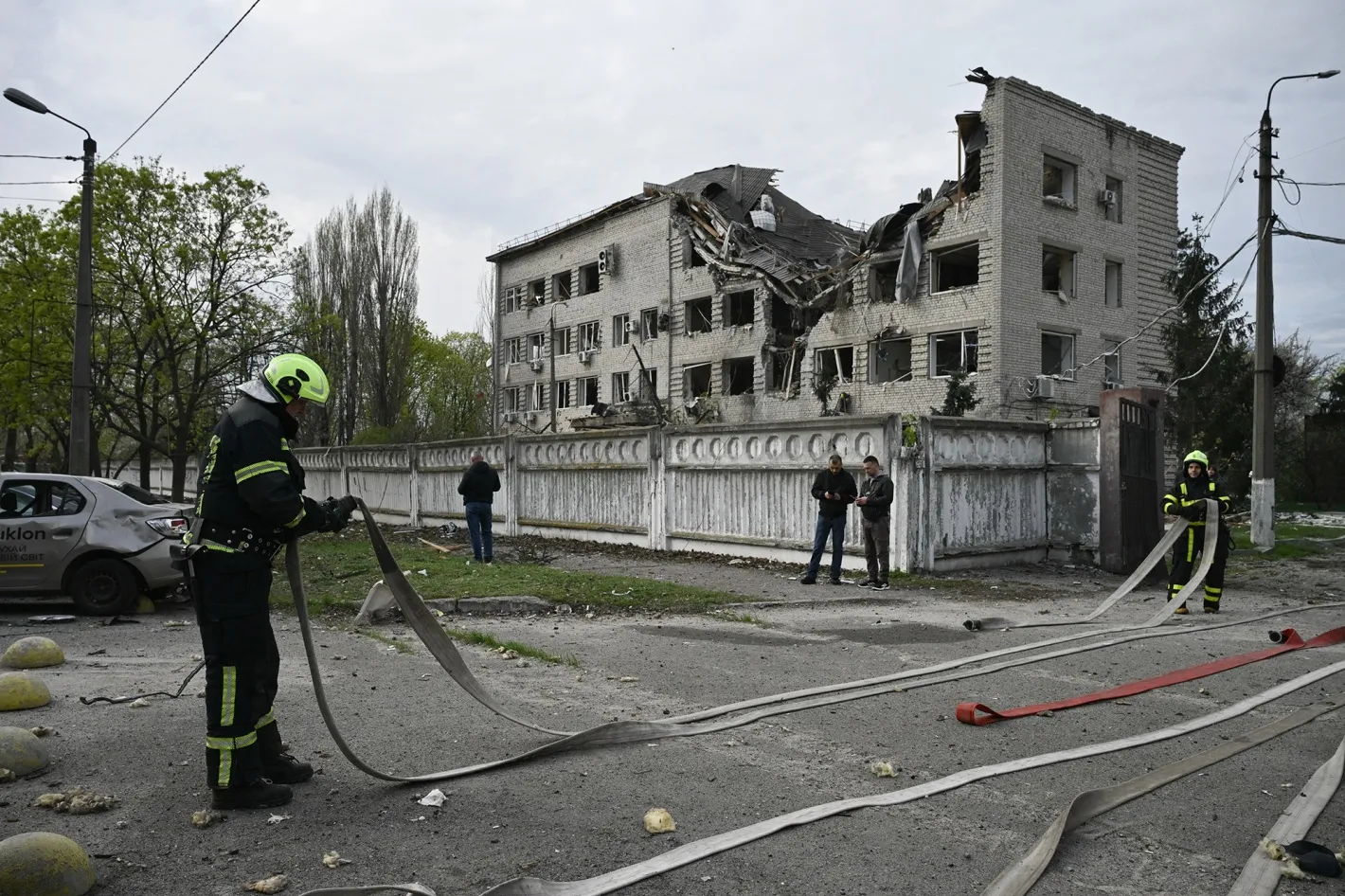 Firefighters work at a site following a Russian strike in Kyiv on April 16.