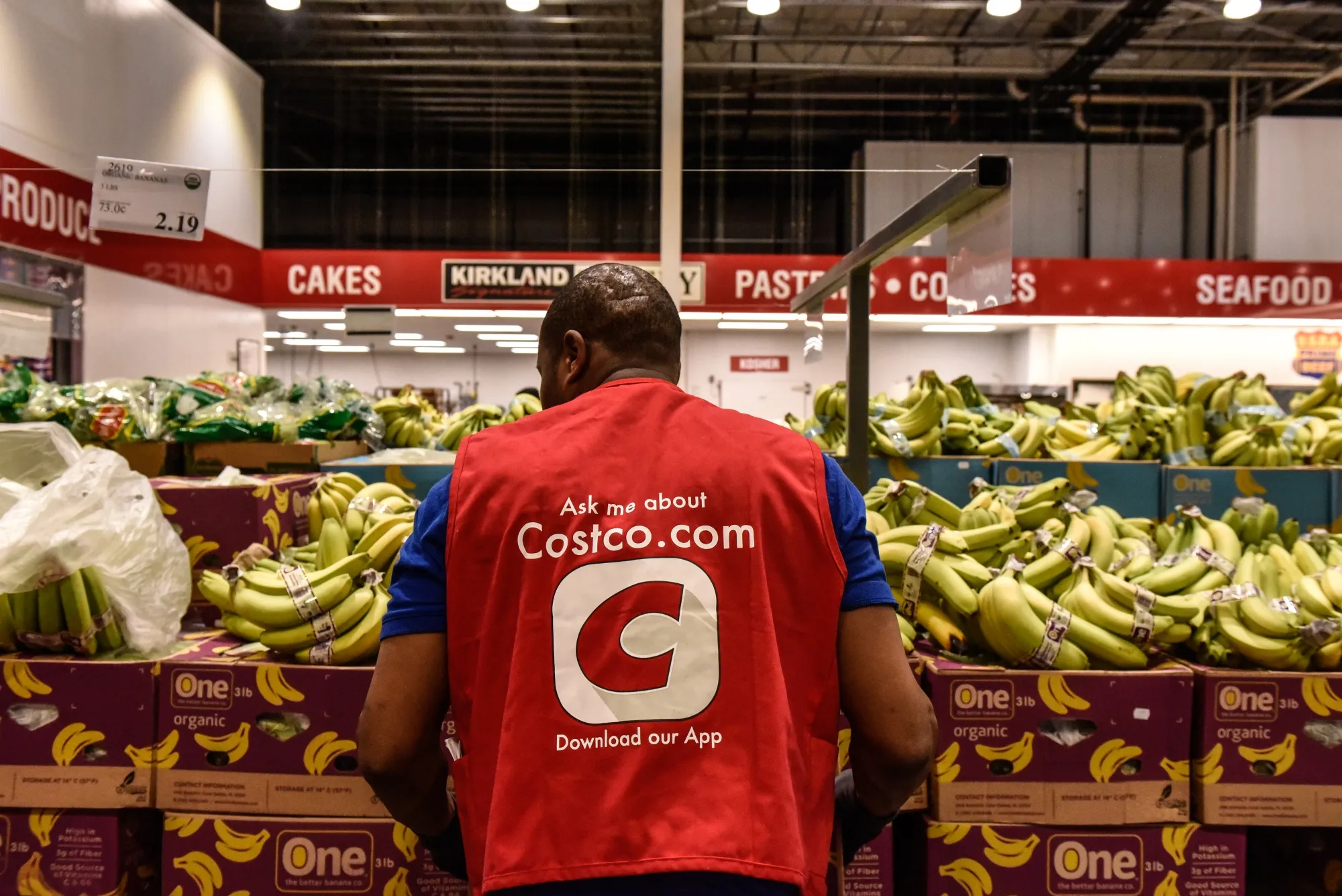 A worker arranges produce at a Costco store in Teterboro, New Jersey.