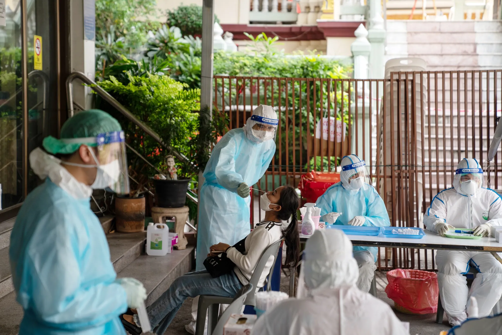 Monks and volunteers conduct free Covid-19 tests at Wat Suthi Wararam, a Buddhist temple, in Bangkok, Thailand.