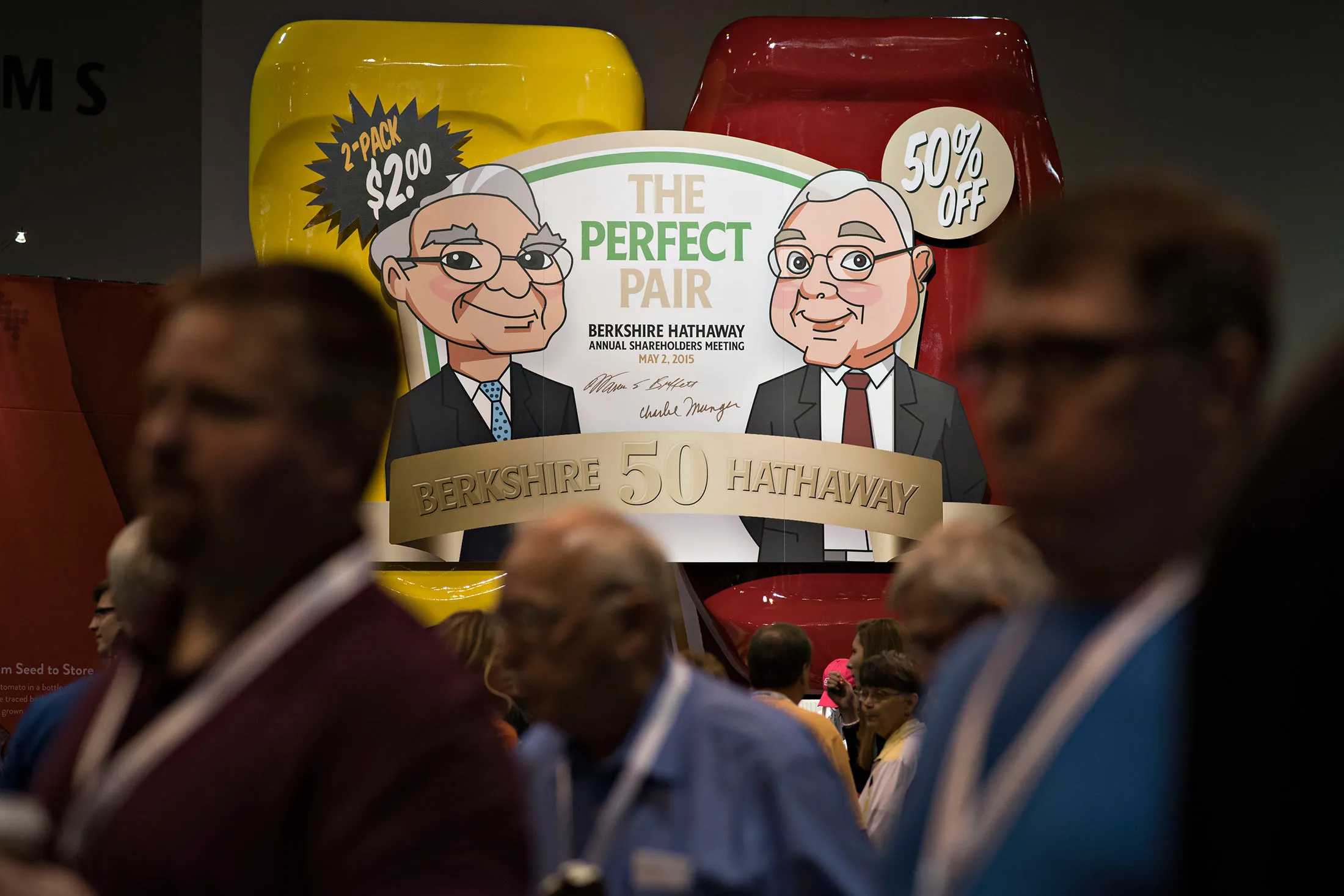 Caricatures of Warren Buffett, Berkshire Hathaway Inc. chairman and chief executive officer, and Charles Munger, vice chairman of Berkshire Hathaway Inc., appear on a sign advertising a special edition package of Heinz ketchup and mustard during the Berkshire Hathaway Inc. annual shareholders meeting in Omaha, Nebraska, on May 2, 2015.
