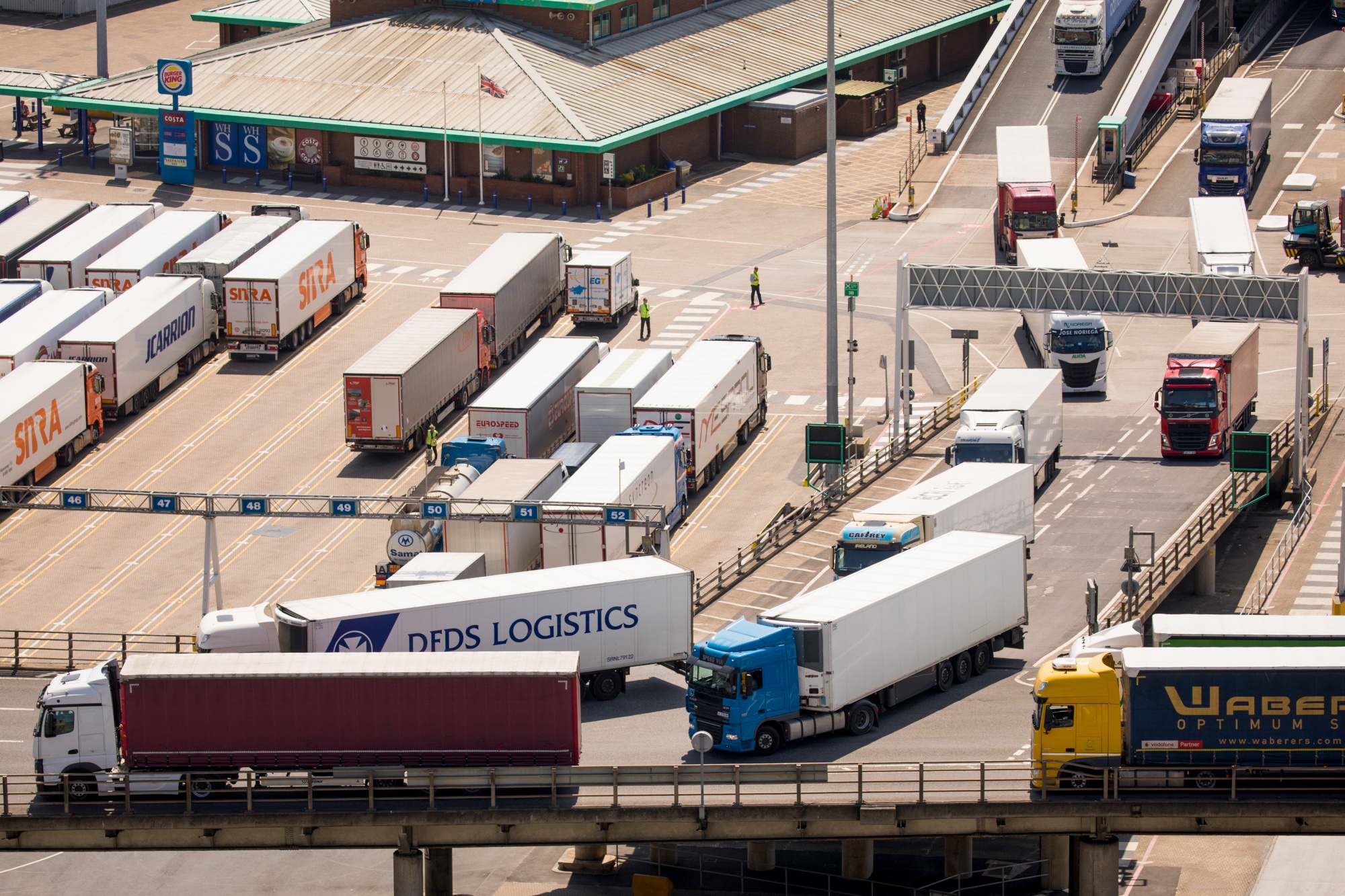 Lorries arrive from a ferry at the Port of Dover on May 27, 2020.