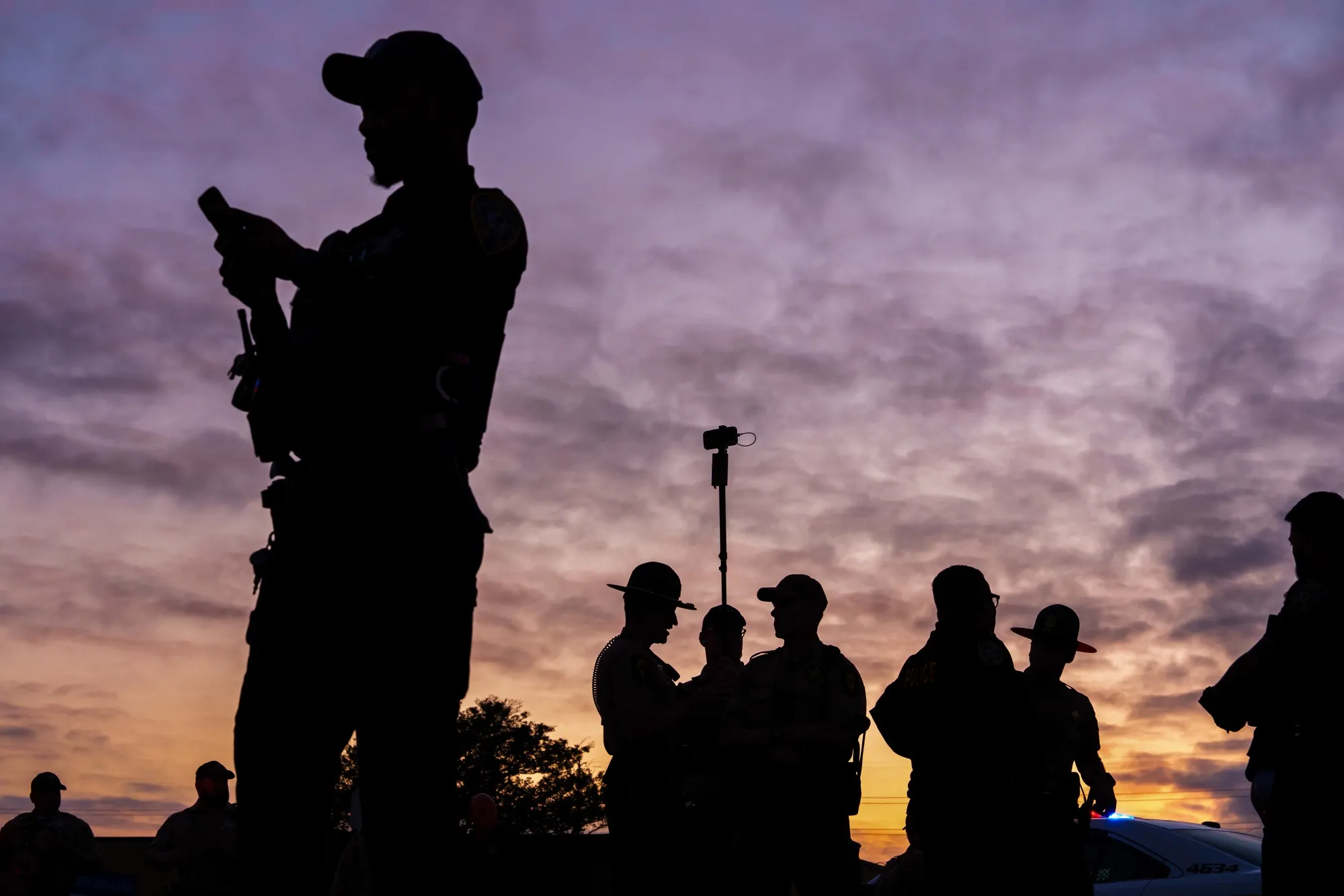 Law enforcement officers outside an Immigration and Customs Enforcement (ICE) processing facility.
