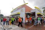 People protest for increased minimum wages near a McDonald's restaurant in the Little Havana area of Miami on Dec. 4