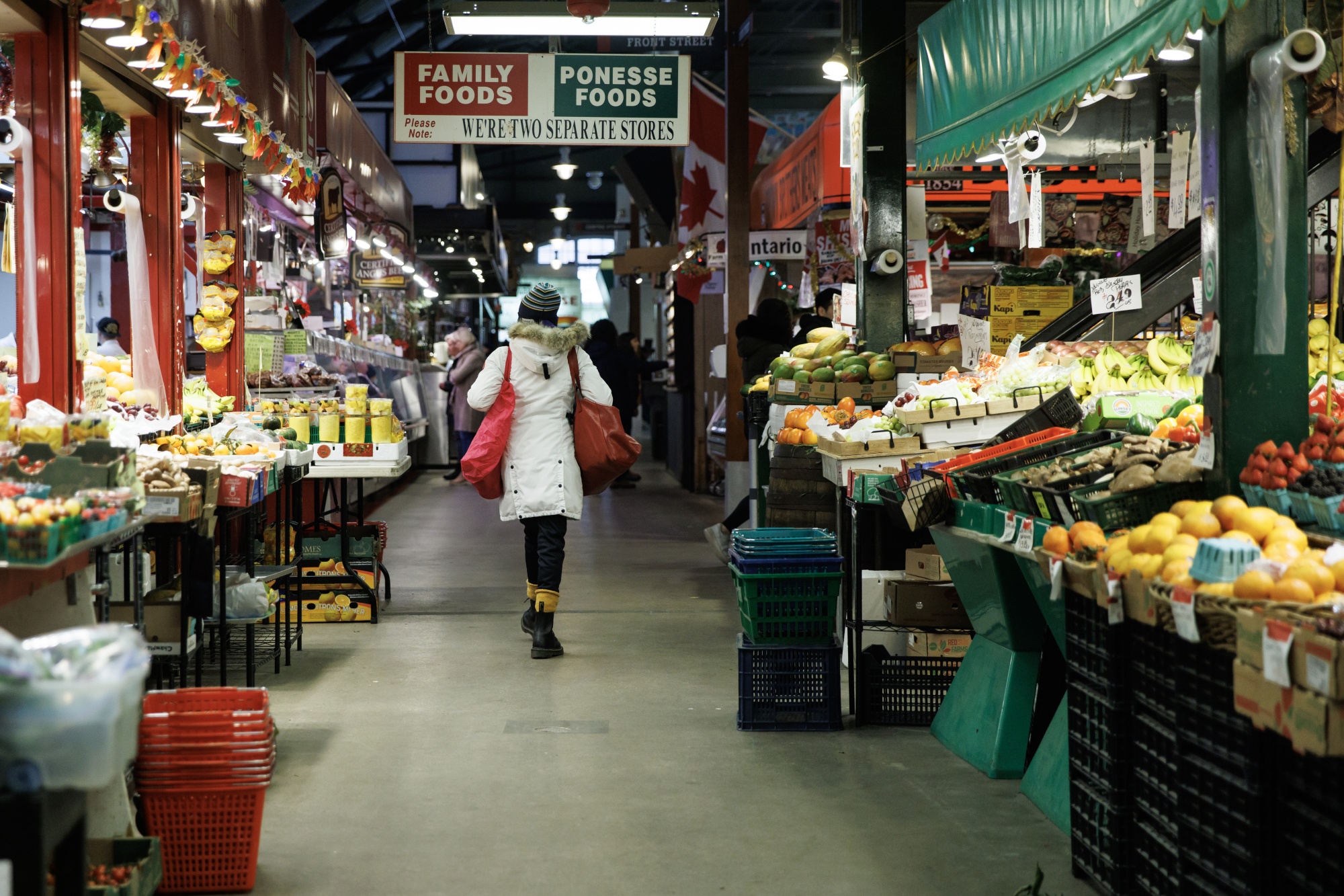 A shopper walks through St. Lawrence Market in Toronto.