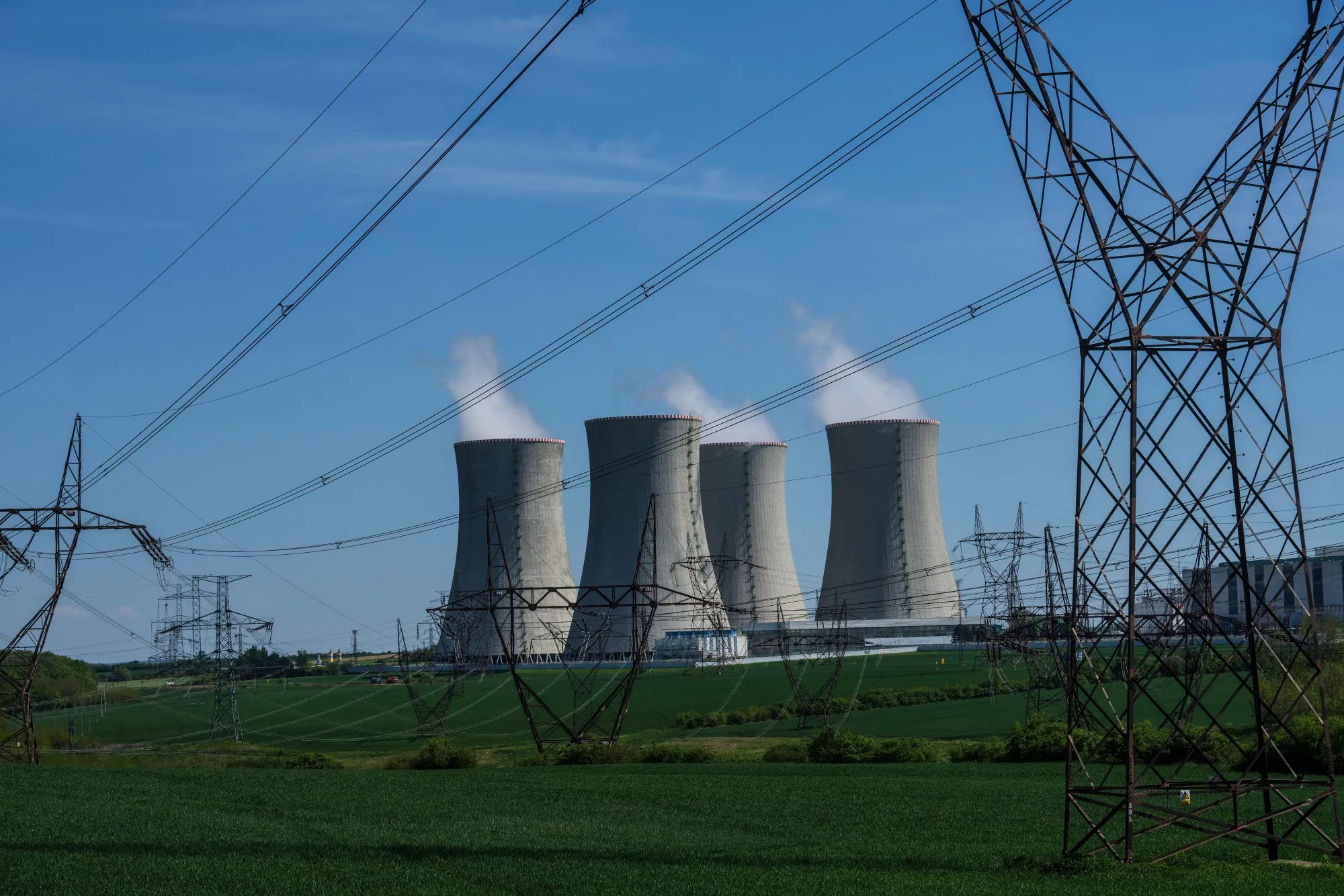 Transmission towers lines near the cooling towers of a CEZ AS nuclear power plant in Dukovany, Czech Republic.