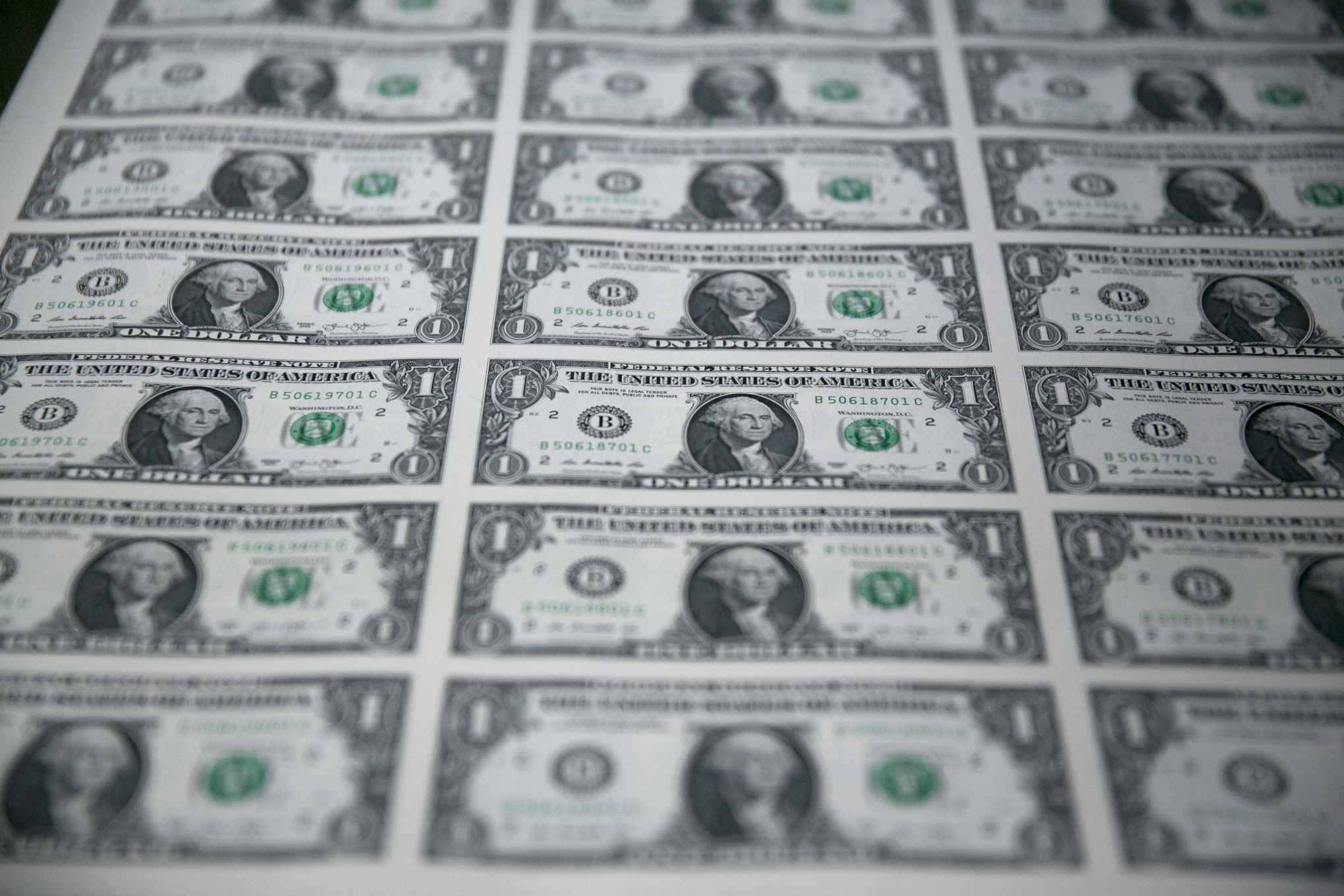 Stacks of 50 subject one dollar note sheets pass through a KBA-NotaSys SA large examining printing equipment machine after receiving a serial number and the U.S. Treasury and U.S. Federal Reserve seals at the U.S. Bureau of Engraving and Printing in Washington, D.C., U.S., on Tuesday, April 14, 2015. Republican efforts to pass a fiscal year 2016 budget cleared another hurdle as the House named its members to a conference committee and Senate Majority Leader Mitch McConnell pledged to do the same by the end of the week. Photographer: Andrew Harrer/Bloomberg