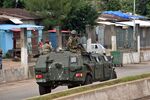 Members of the Armed Forces of Guinea drive through the central neighbourhood of Kaloum in Conakry on September 5, 2021 after sustainable gunfire was heard. - Gunfire was heard in Conkary in the morning and troops were seen on the streets, witnesses told AFP. There was no immediate explanation for the incidents in Conakry's Kaloum peninsula, where the presidency, various institutions and offices are located. (Photo by CELLOU BINANI / AFP) (Photo by CELLOU BINANI/AFP via Getty Images)