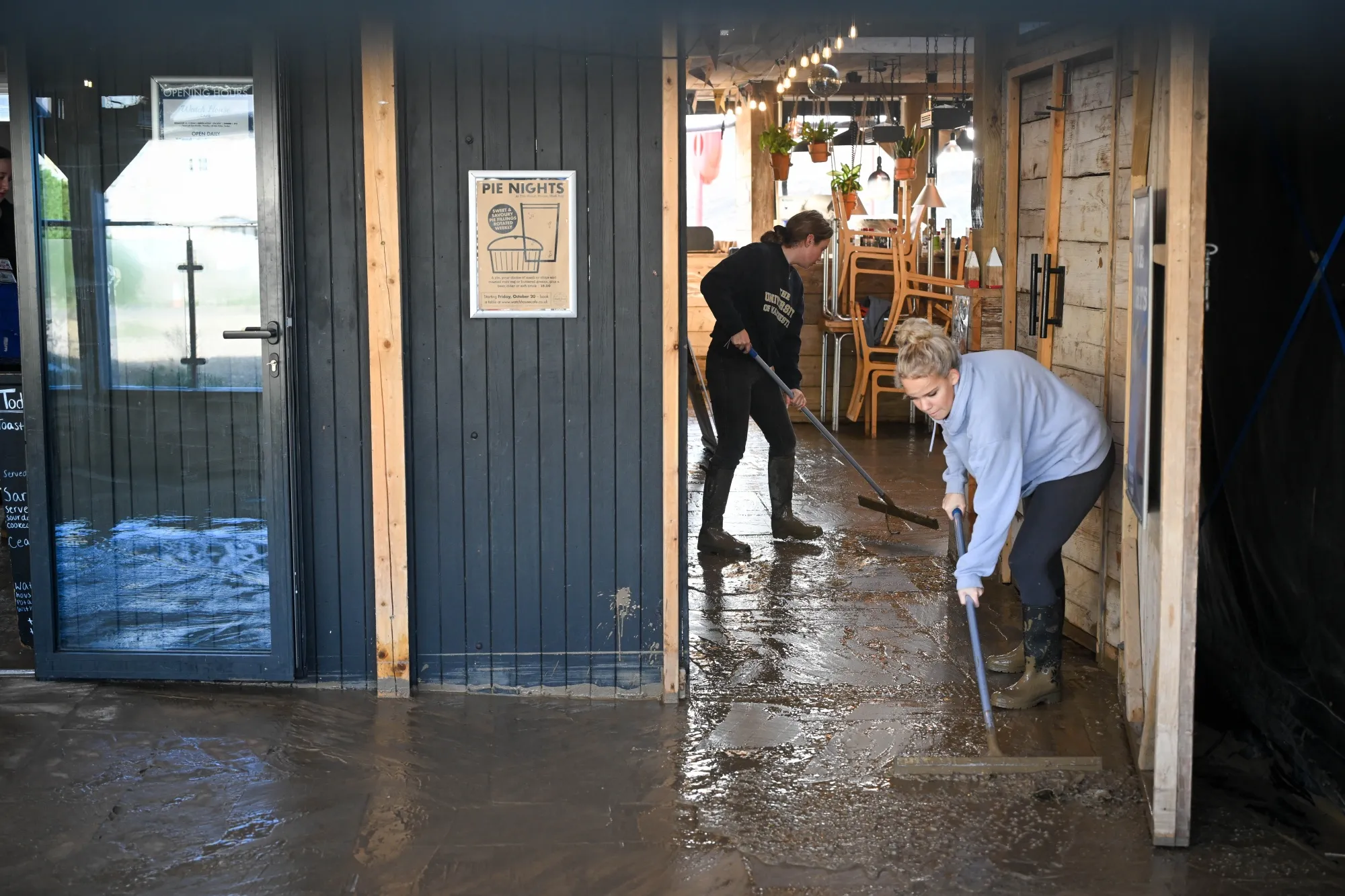 Members of the staff clear up after the storm at a cafe in West Bay, Dorset, on Nov. 3.&nbsp;