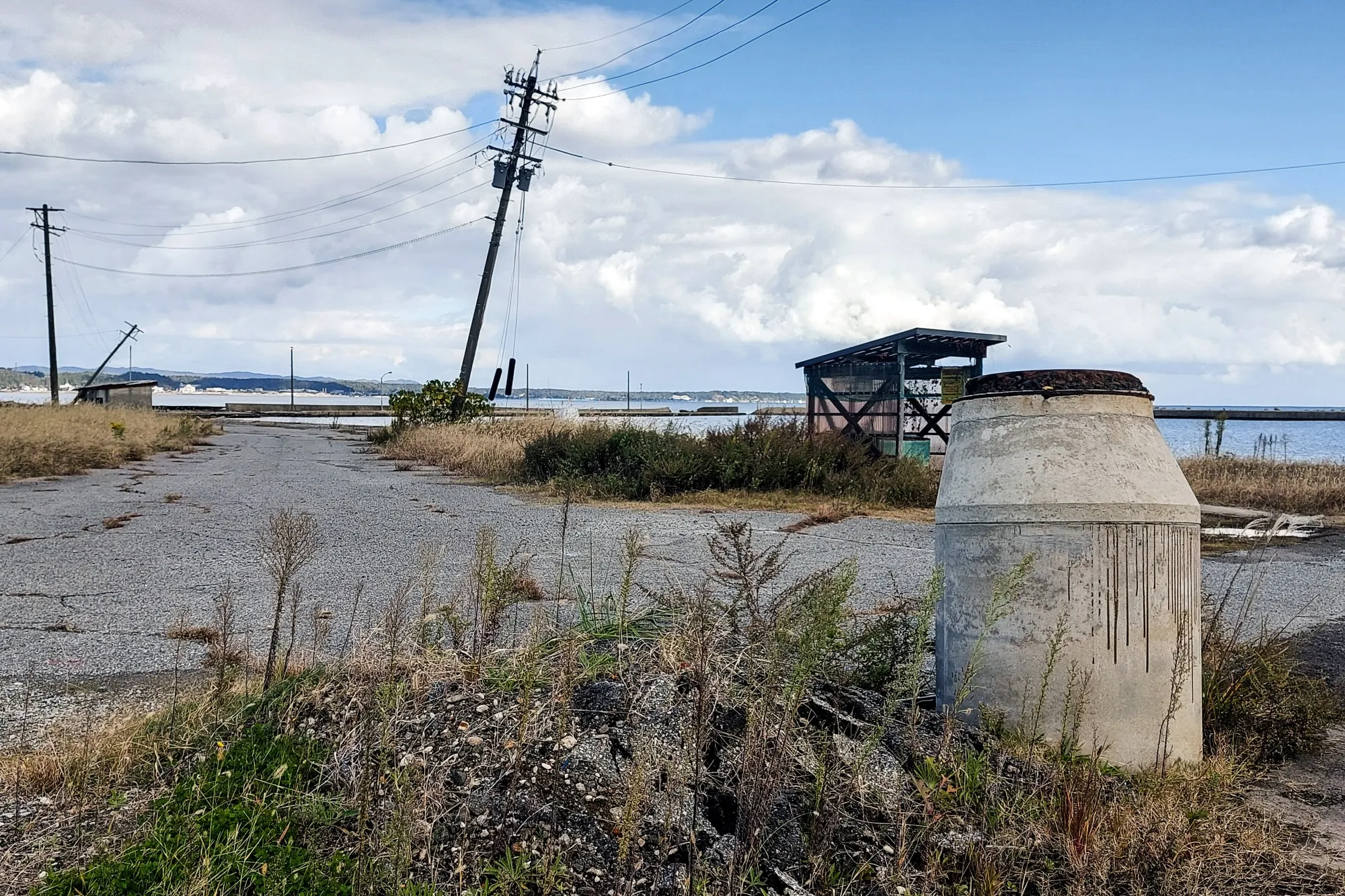 A manhole lifted by the 2024 Noto Peninsula earthquake remains near Ukai Port in Ishikawa Prefecture in November.