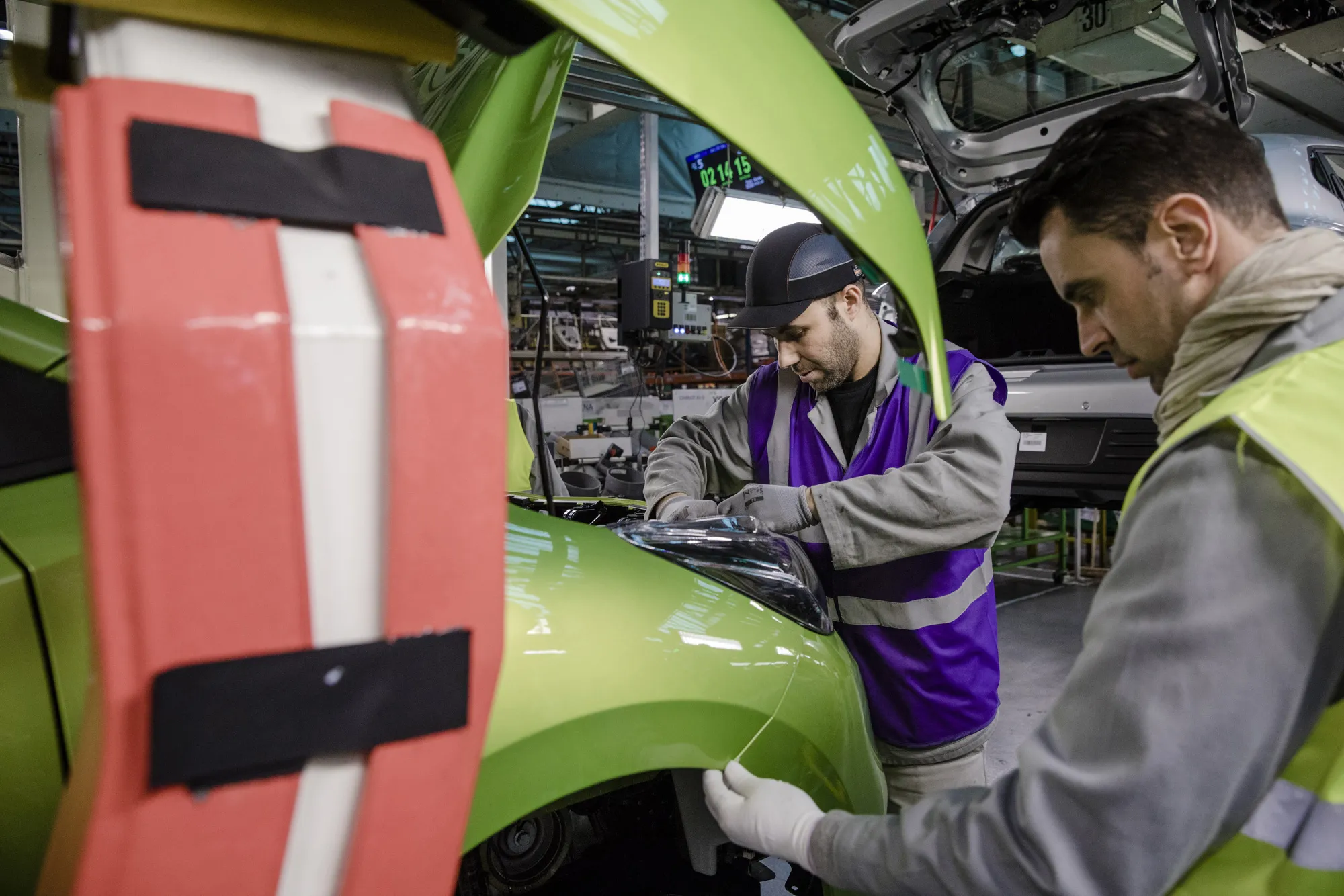 Employees fix fittings to a Nissan Micra automobile inside the Renault SA factory in Flins, France, on Thursday, Feb. 23, 2017. Carlos Ghosn, one of the auto industry's most celebrated turnaround artists, is relinquishing his CEO role at Nissan Motor Co. and turning over day-to-day control to Hiroto Saikawa as he focuses on strengthening the carmaker's alliance with Renault and Mitsubishi Motors Corp.