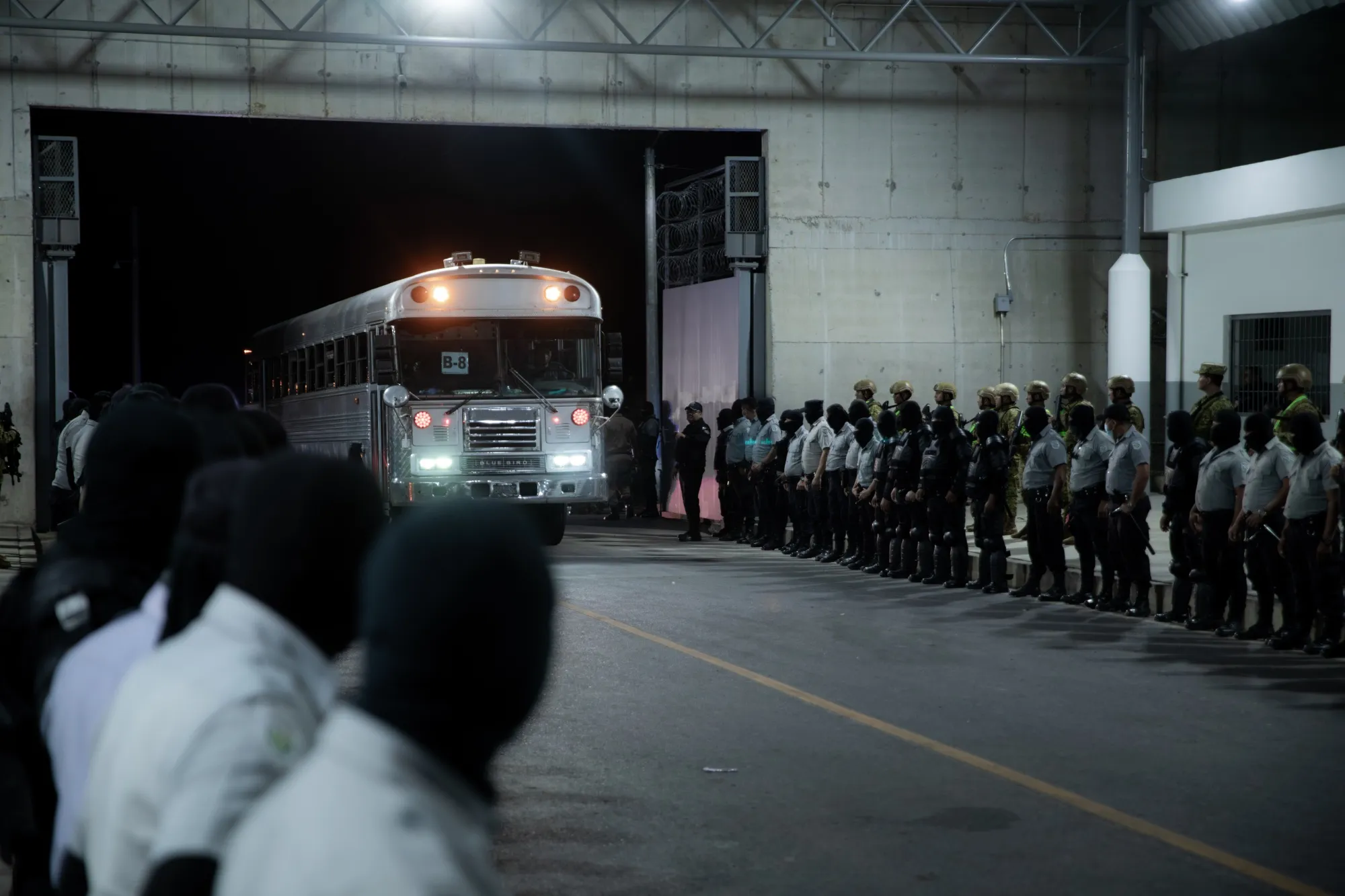 In this photo released by the El Salvador Presidency, buses arrive at the Terrorism Containment Center maximum security prison with deported individuals from the US, on March 16.