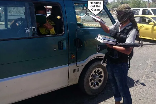 A driver is stopped at an ISIL checkpoint