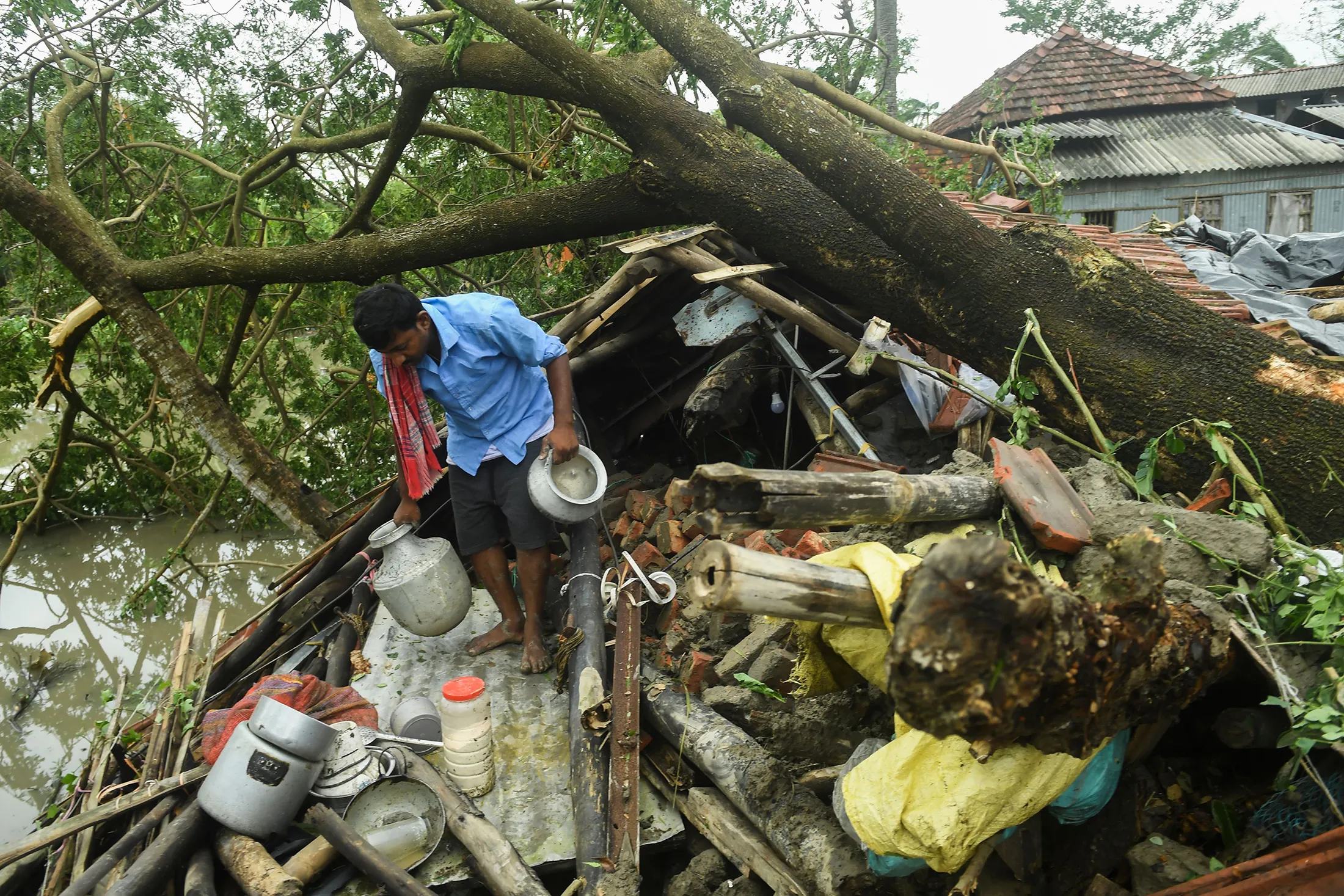 A man salvages items from his house damaged by cyclone Amphan in Midnapore, West Bengal, India, on May 21.