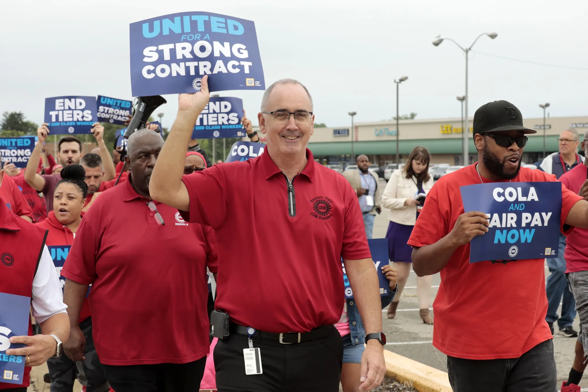 Shawn Fain, center, walks with demonstrators during a UAW practice picket outside the Stellantis Mack Assembly Plant in Detroit, Michigan, on Aug. 23.