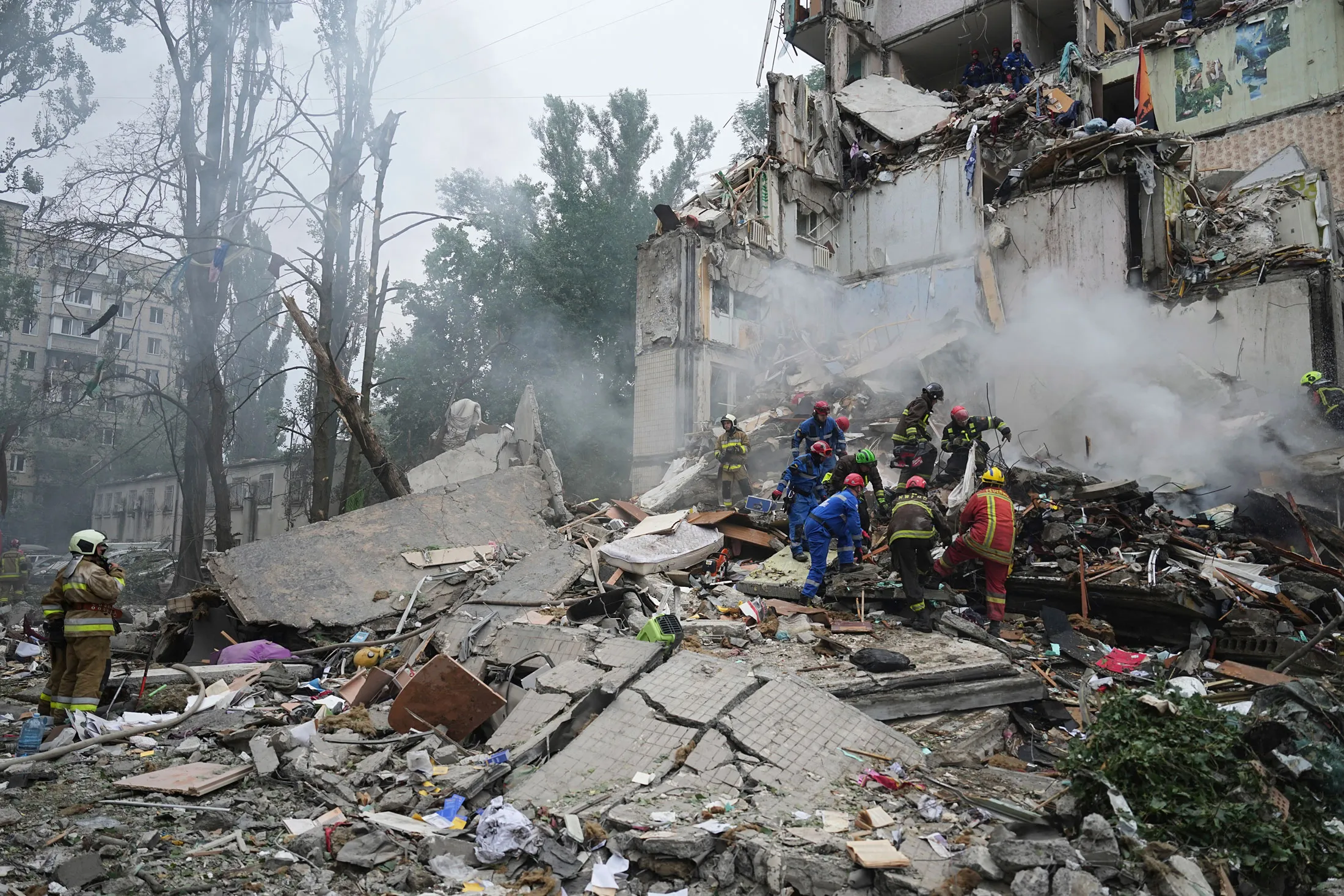 Emergency services at the site of a Russian attack in Kyiv on July 31.