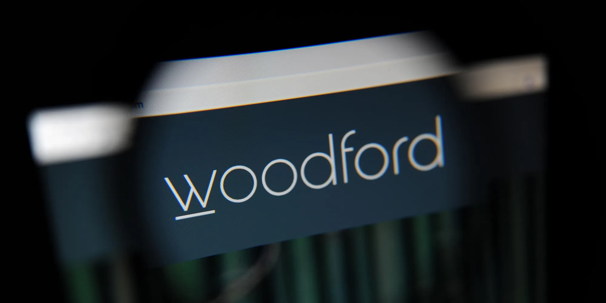 Woodford funds website seen through a magnifying glass
