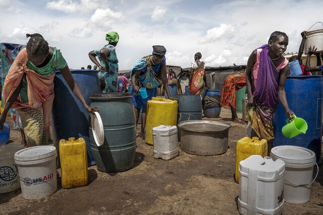 Rier villagers collect water from a delivery point serviced weekly by the oil company, near oil fields once operated by Petronas.