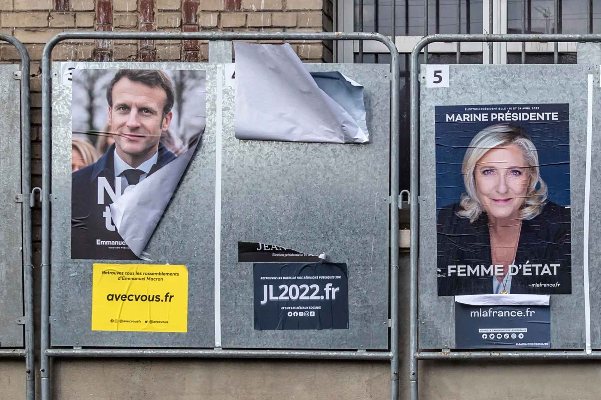 Electoral posters for France's President Emmanuel Macron, left, and presidential candidate Marine Le Pen on notice boards in Lens, France.