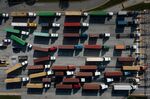 Trucks transport cargo containers at the Port of Baltimore in Baltimore, Maryland.