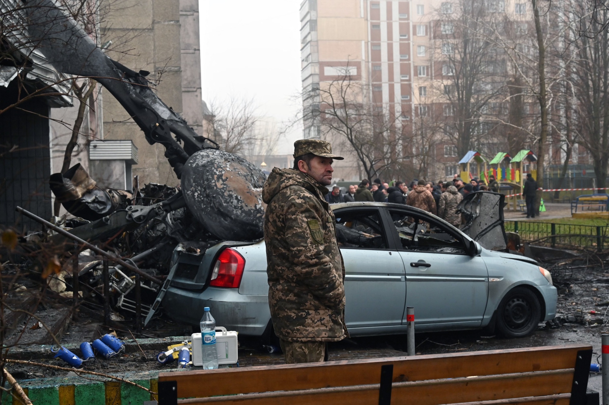 Security personnel attend the scene of a helicopter crash in Brovary, near Kyiv on Jan. 18.