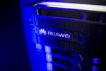 The Huawei Technologies Co. logo is displayed on a storage system inside an exhibition hall at the company's campus .