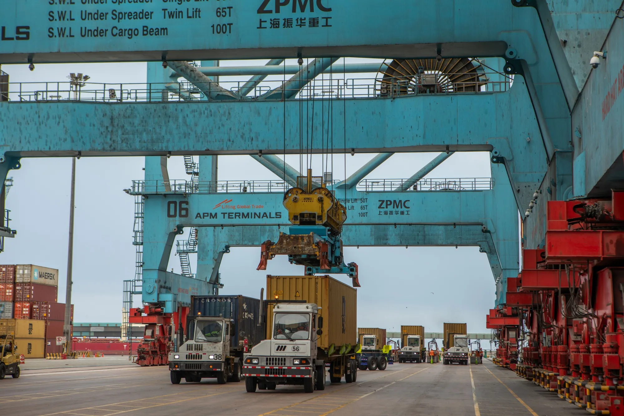 A gantry crane lifts shipping containers to be loaded onto a ship at the APM Terminals in the Port of Callao in Callao, Peru, in November 2025.