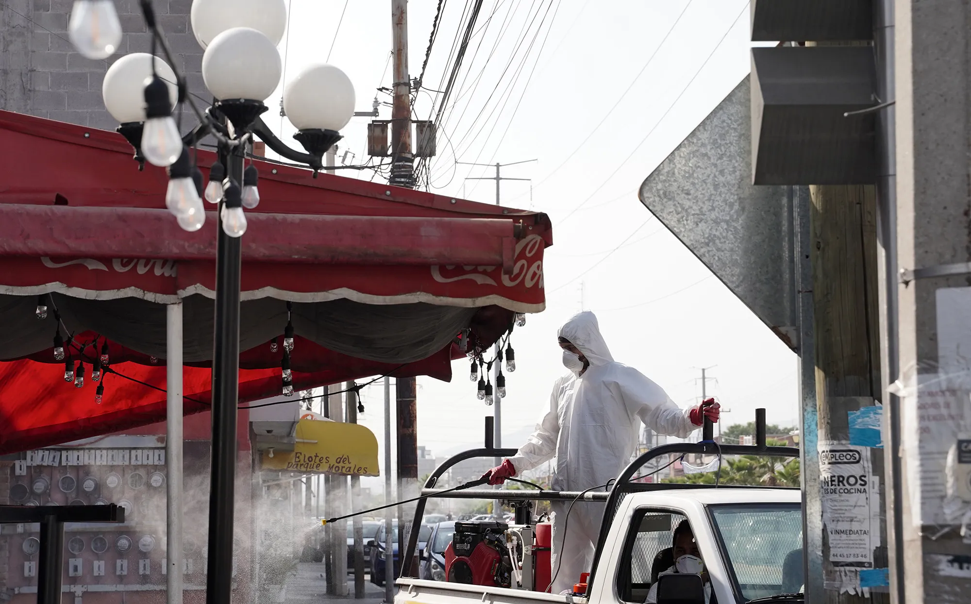 Workers from the Municipal Civil Protection Unit disinfect outside a restaurant in San Luis Potosi, Mexico&nbsp;on&nbsp;April 28.