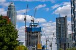 Construction cranes surround a residential tower developed by Guangzhou R&amp;F Properties Co. in&nbsp;London, U.K.