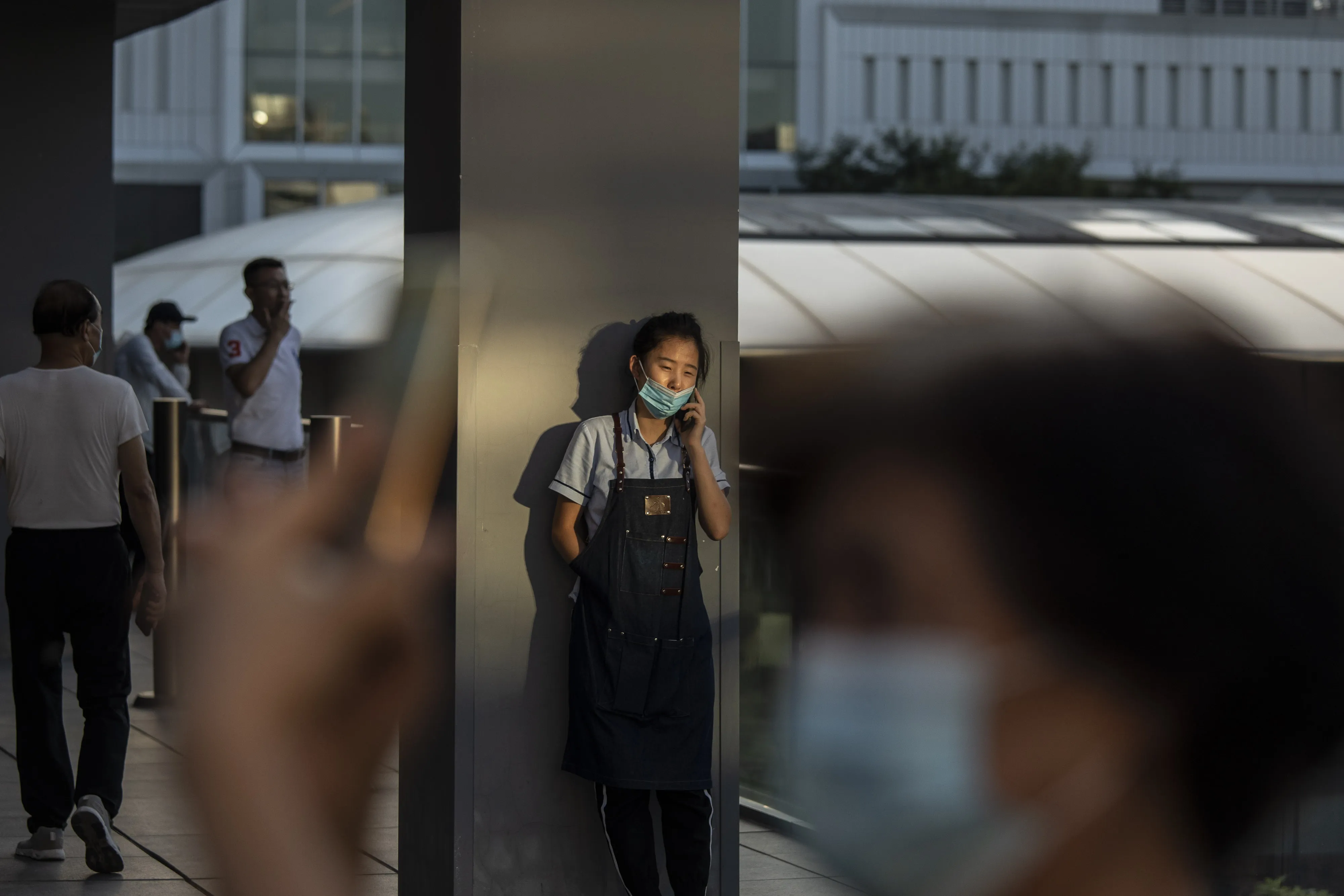 A worker during a break at an upscale retail area in Beijing.&nbsp;