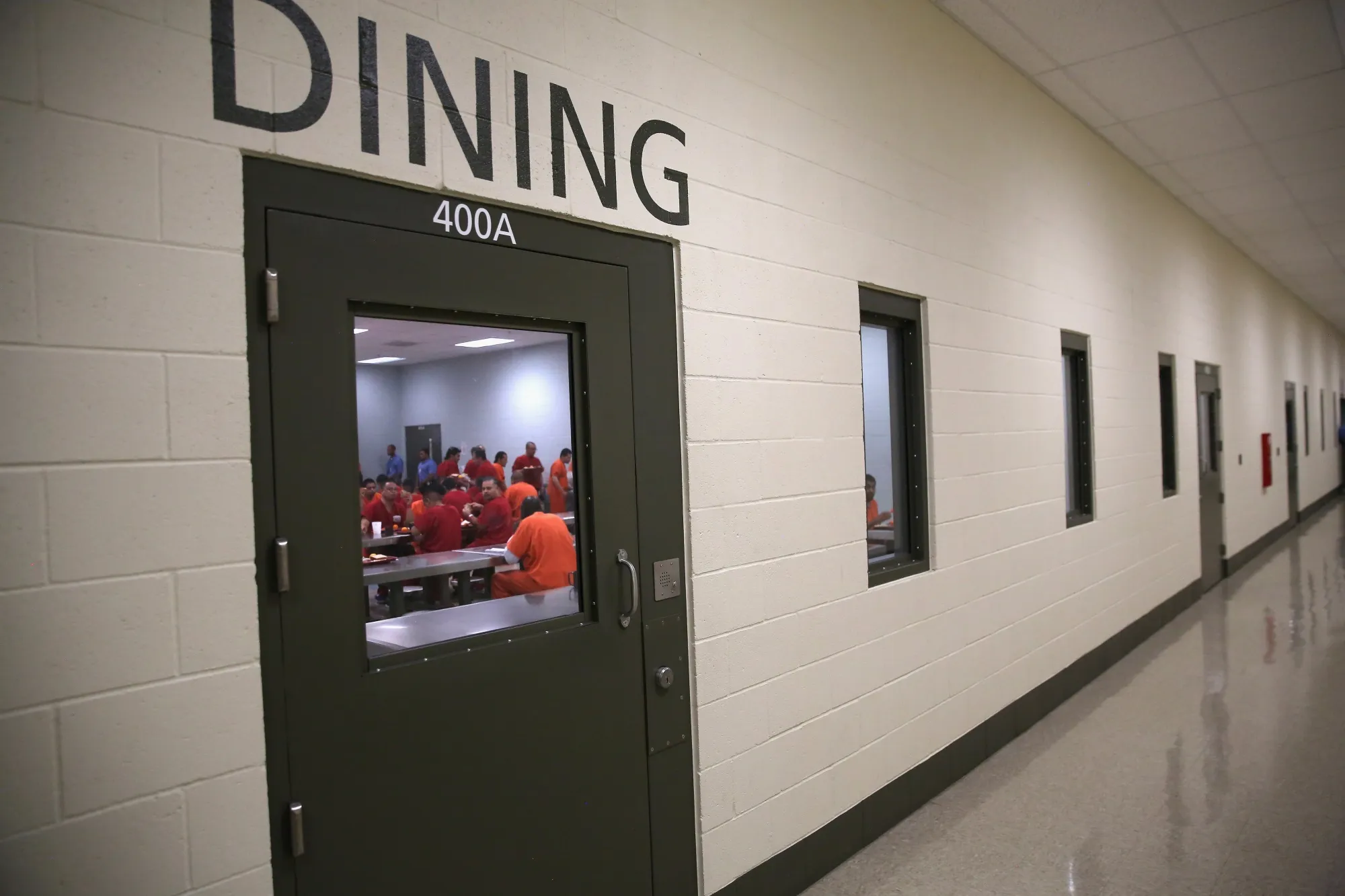 Detainees eat lunch at a detention facility.