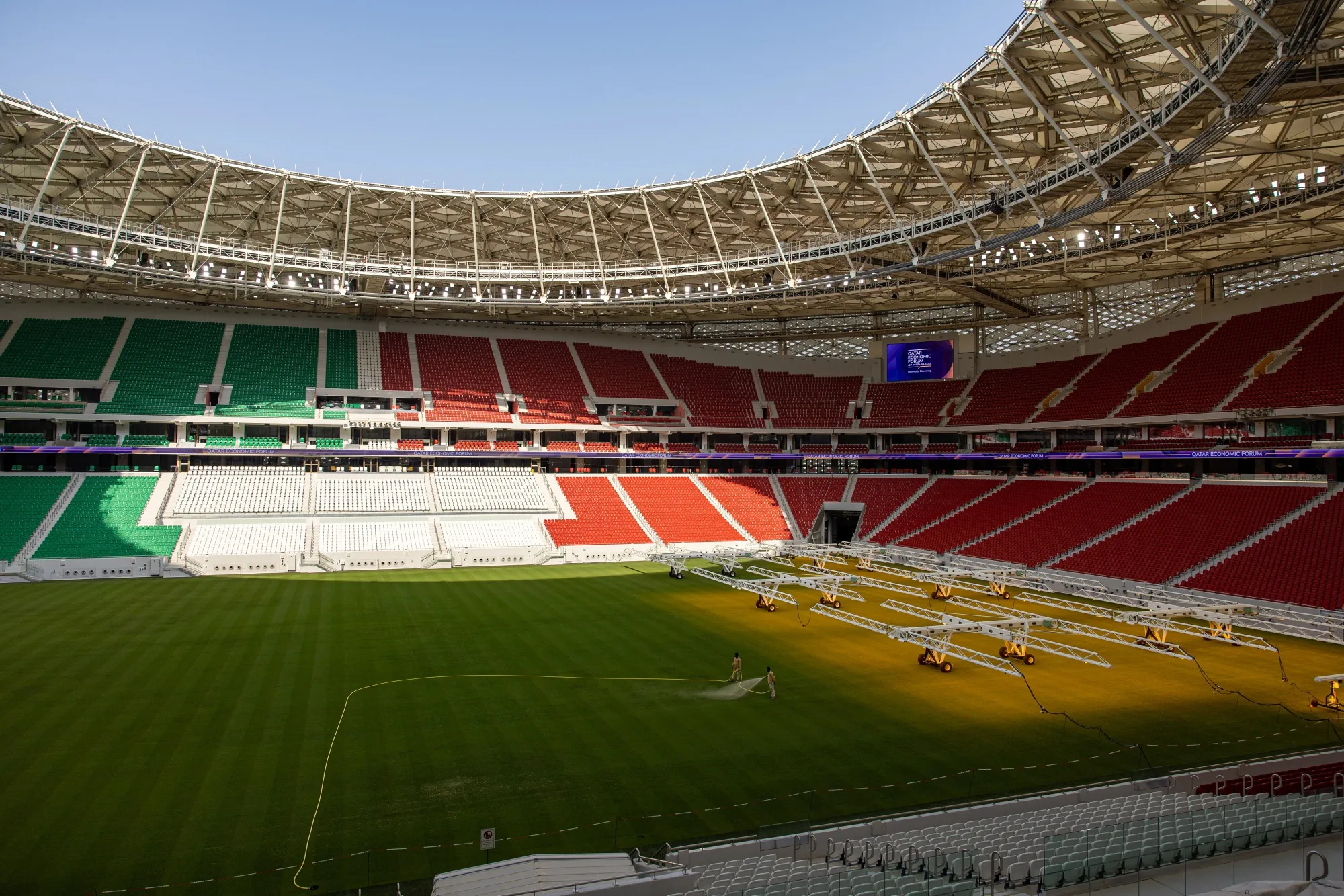 Grounds crew water the grass pitch surface of the Al Thumama football stadium in Doha, on June 20.