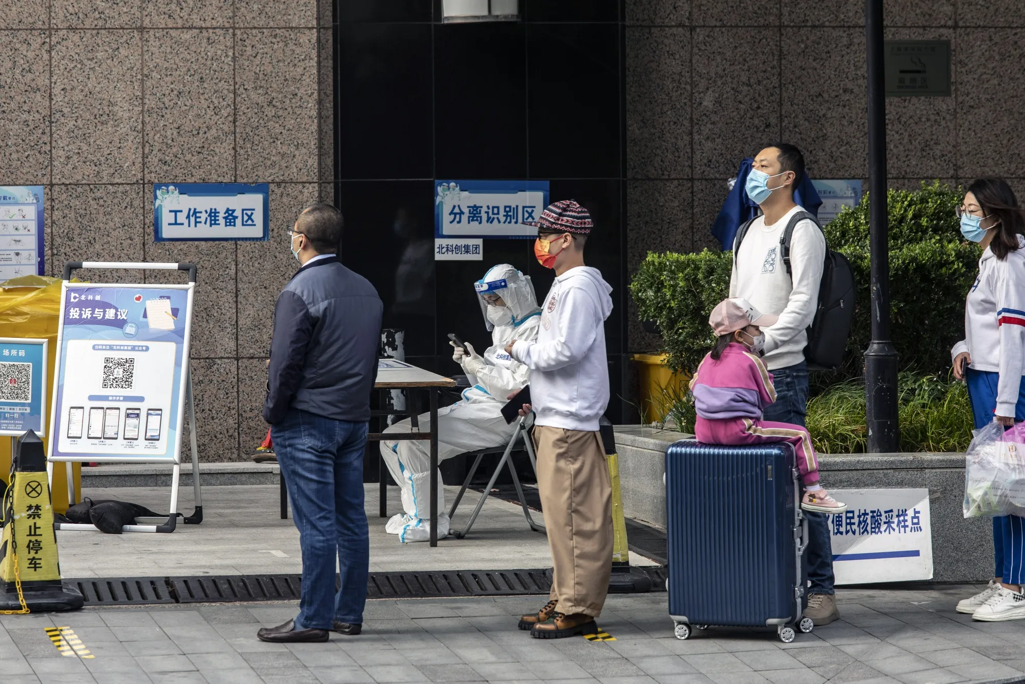 Residents queue at a Covid-19 testing station in Shanghai on Oct. 17.