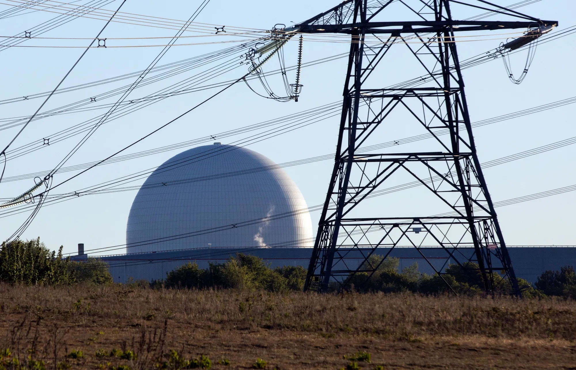 Electricity transmission towers stand aside&nbsp;the Sizewell B nuclear plant. The UK will invest £14.2 billion ($19.2 billion) to help build Sizewell C nearby.