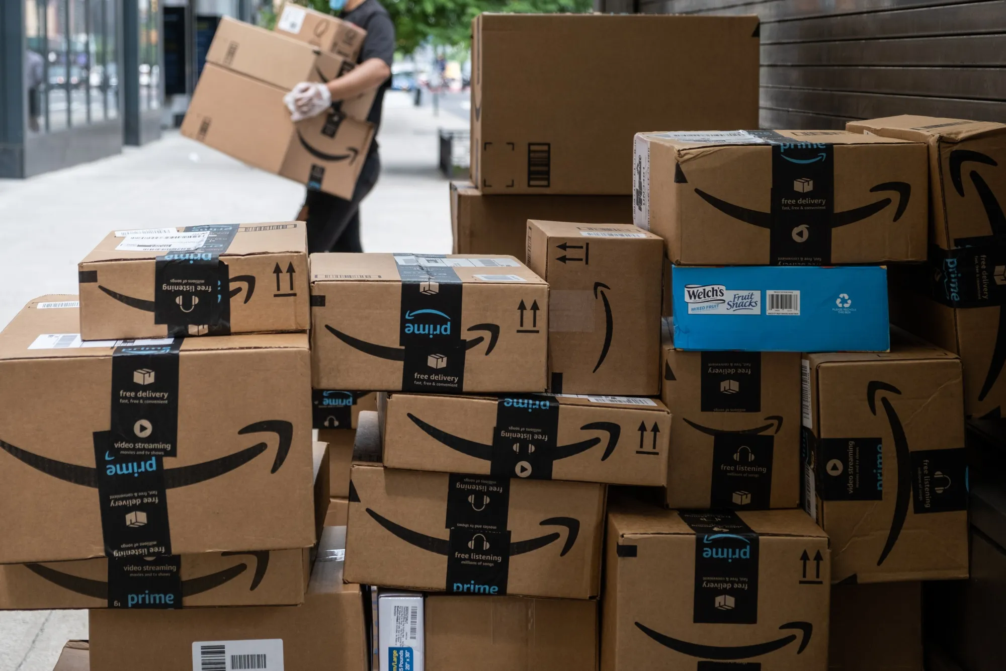 Amazon.com Inc. packages stacked on a sidewalk in New York.