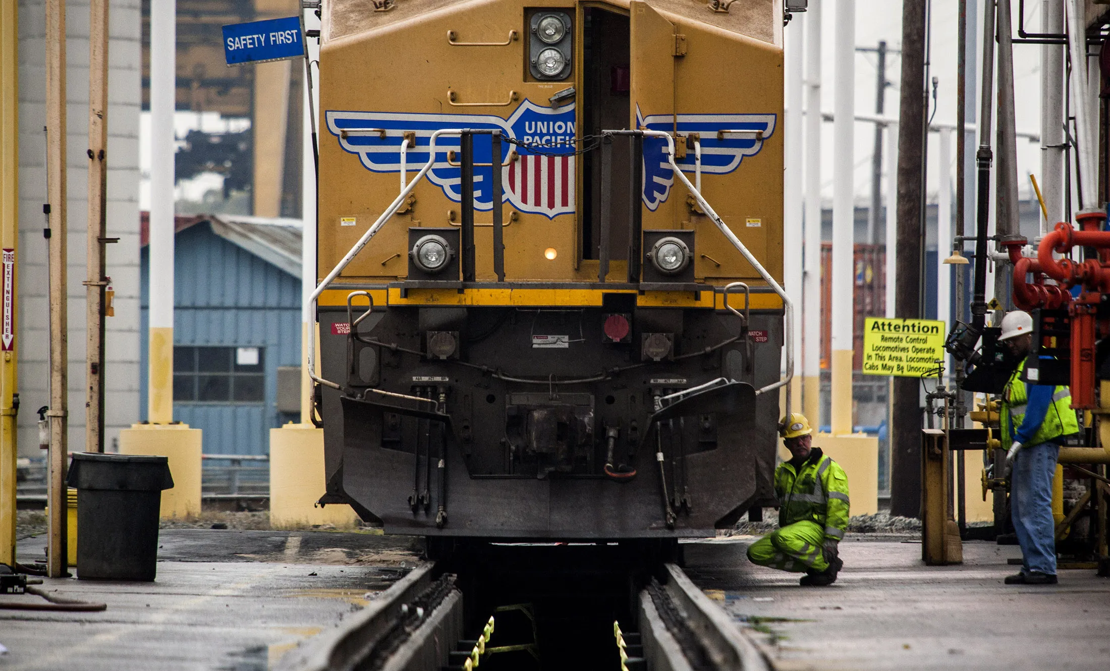 Workers inspect a freight locomotive at the Union Pacific Intermodal Terminal in Oakland, California.
